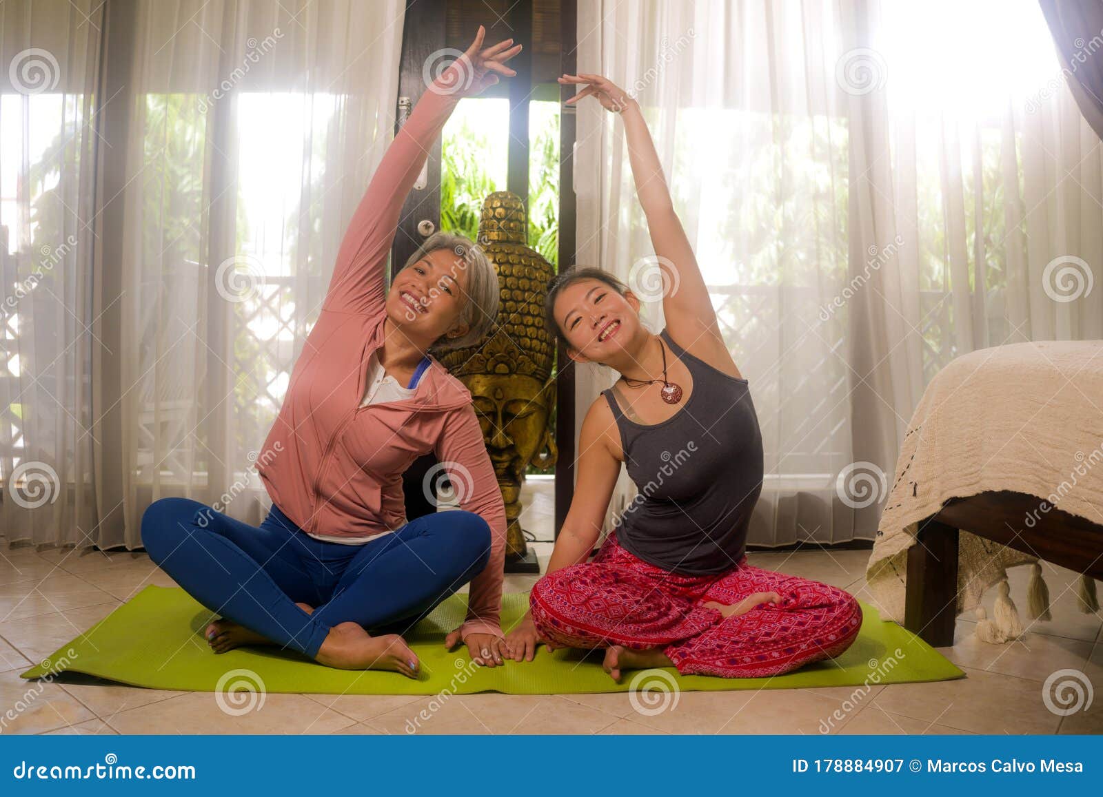 Happy Girlfriends Yoga Workout At Home Two Beautiful Asian Women Practicing Yoga And