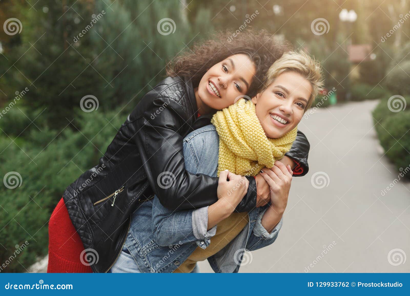 Happy Girls Having Fun While Walking In The Park Stock