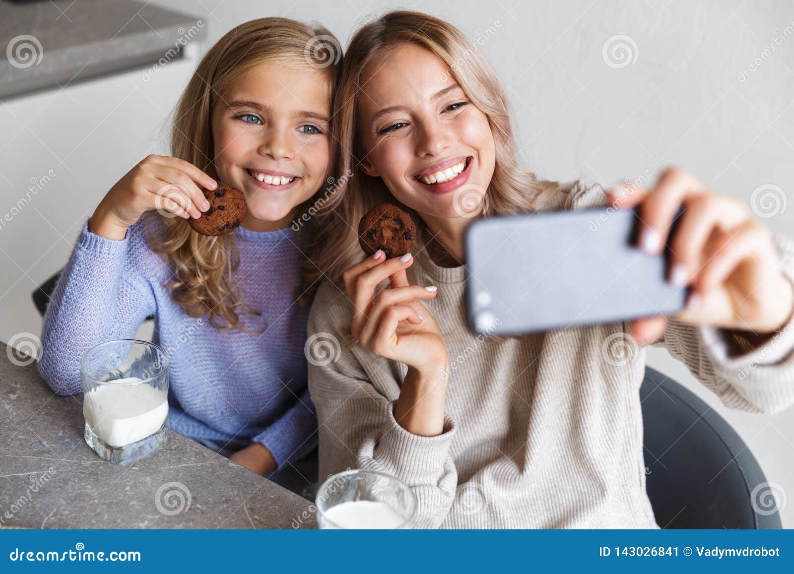 Happy Girls Sisters at Kitchen Indoors Eat Have a Breakfast Together ...