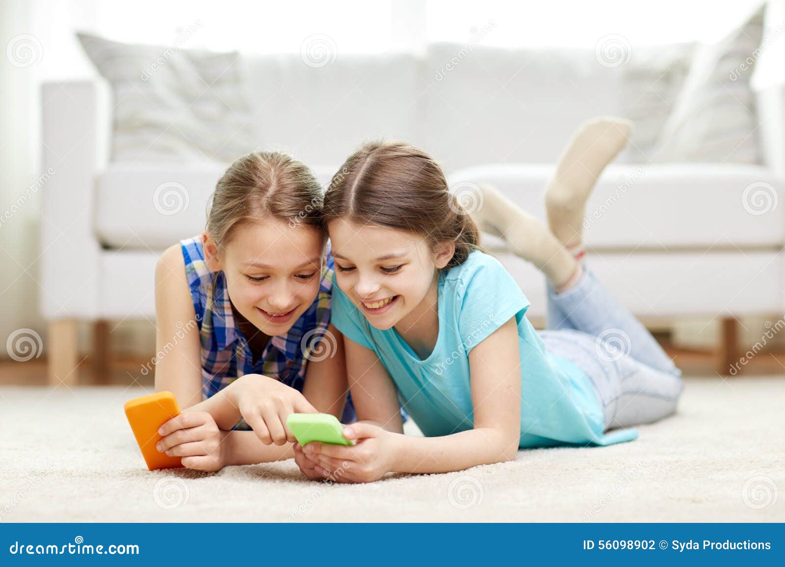 Happy Girls with Smartphones Lying on Floor Stock Photo - Image of ...