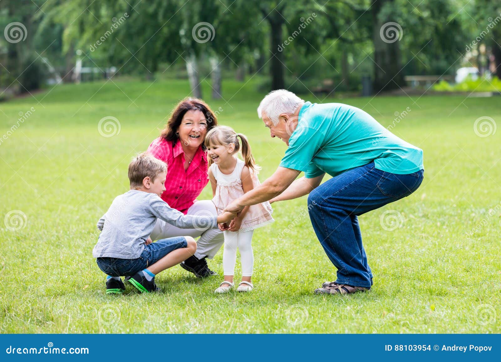 happy grandparent and grandchildren in park