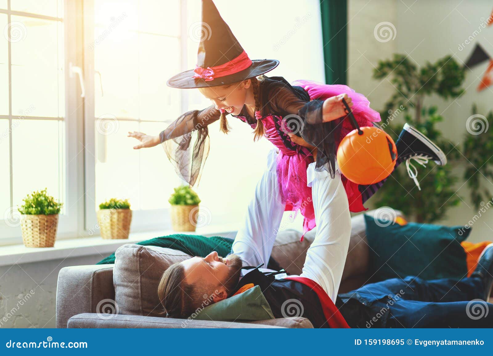 Happy Halloween. Family Father and Daughter Child Play in Costumes