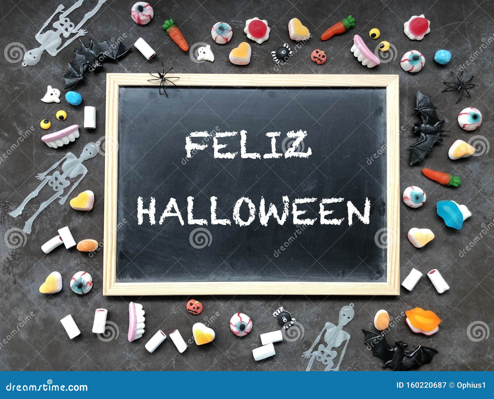 Happy Halloween Text in Spanish. Candy Flat Lay and Blackboard on Textured Dark Background Stock Image - Image of panoramic, holding: 160220687