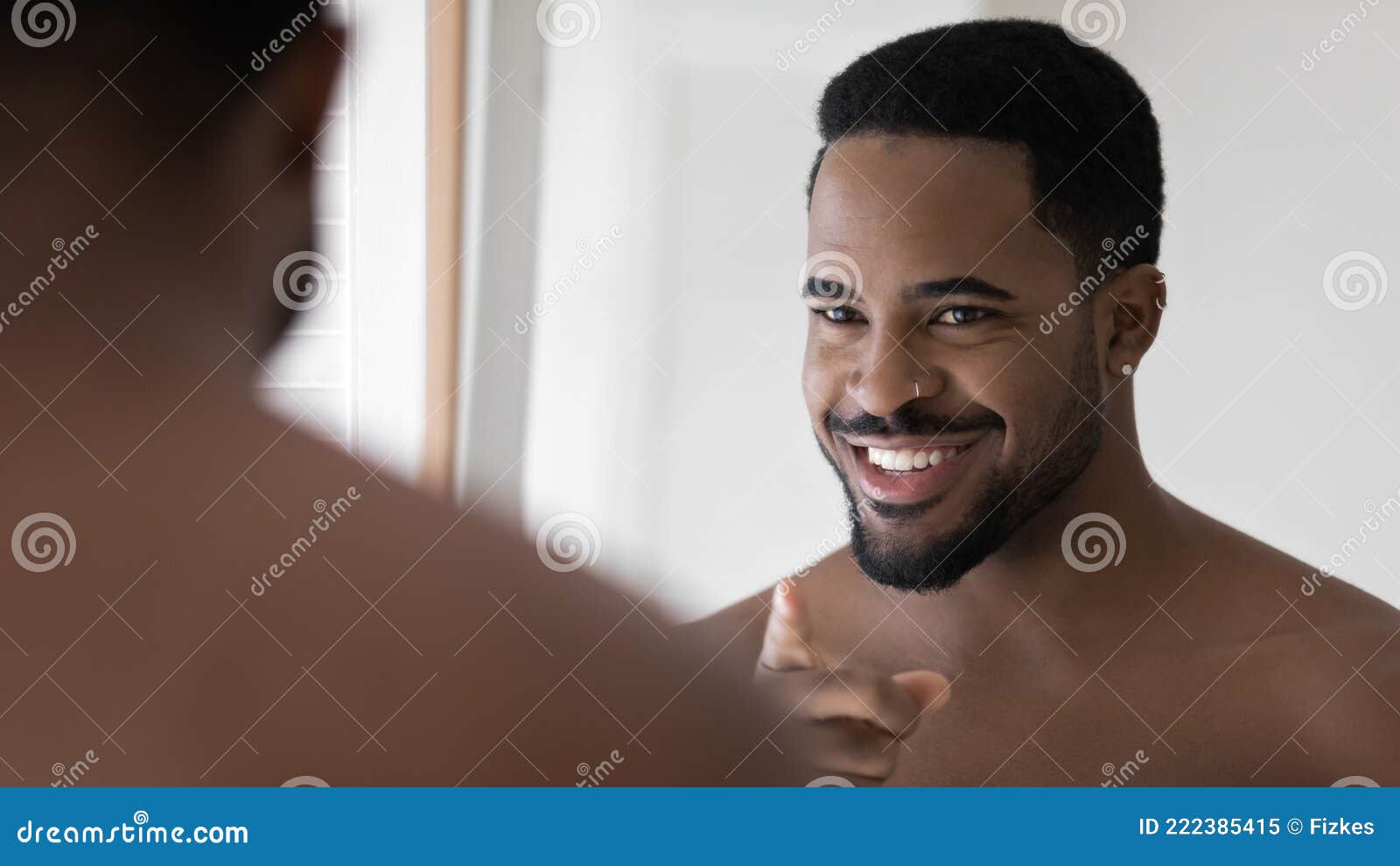 happy handsome black metrosexual guy with facial piercing