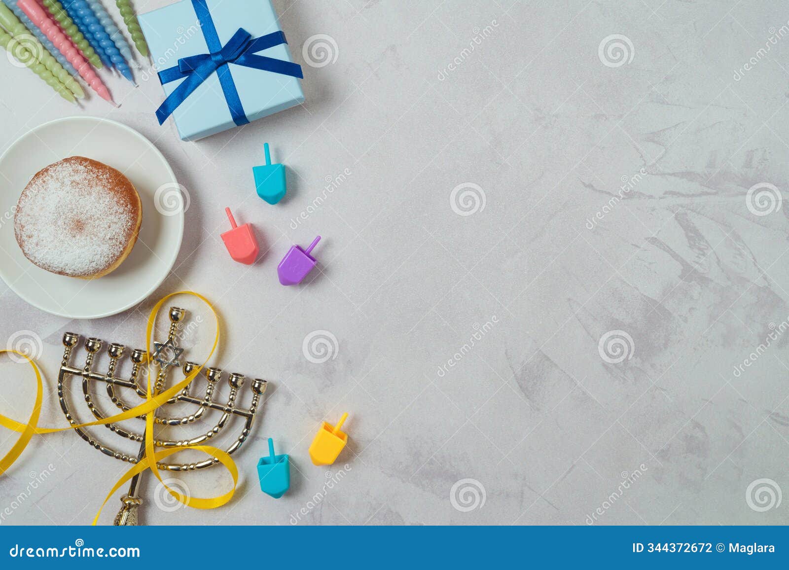happy hanukkah border background with traditional donuts, menorah, colorful candles and gift box. top view, flat lay