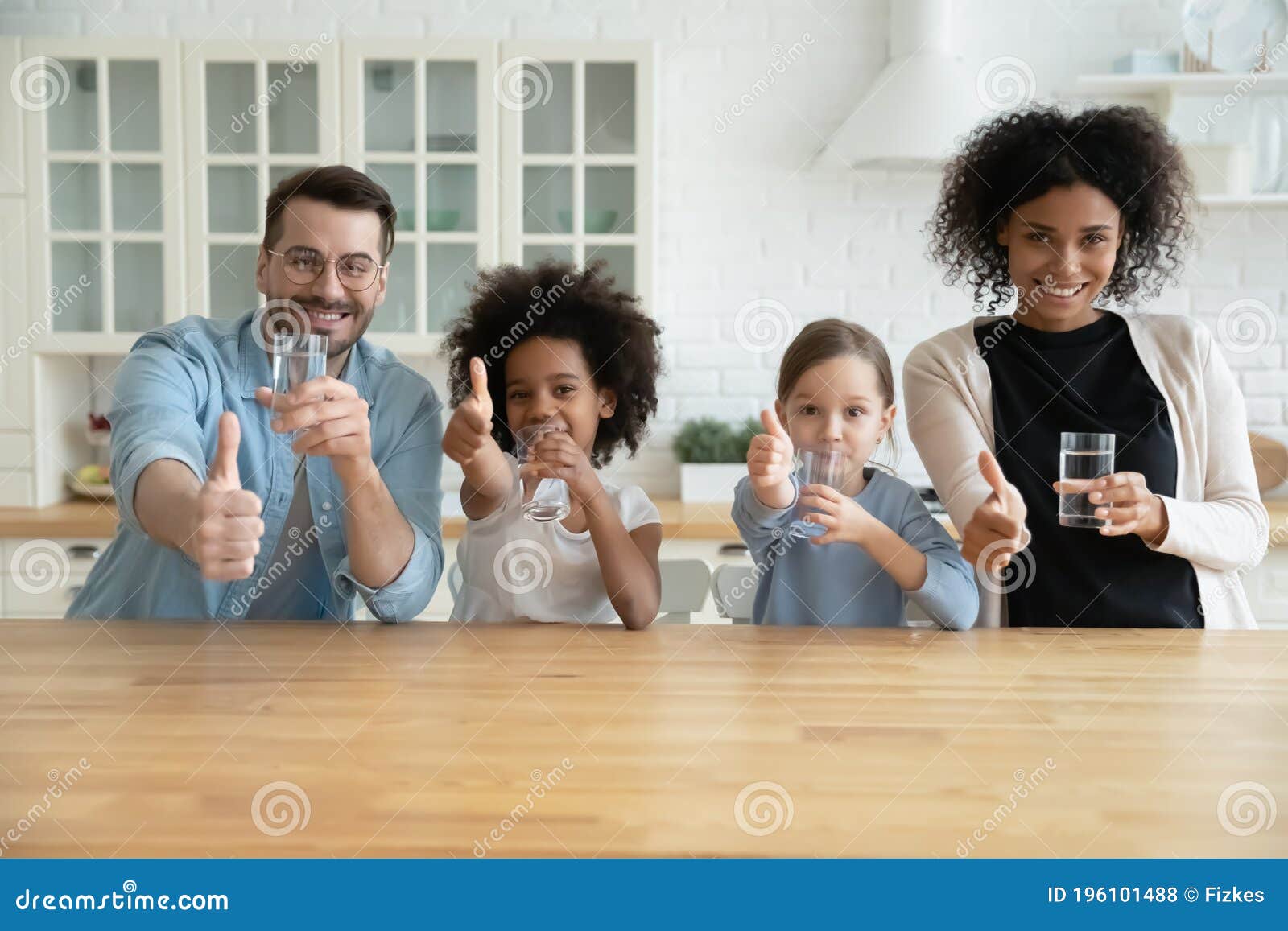happy healthy mixed race family recommending drinking water.