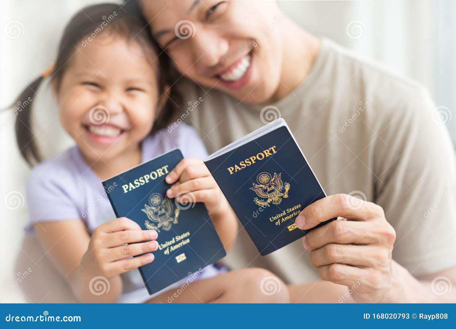 happy immigrant family becoming new american citizens, holding us passports