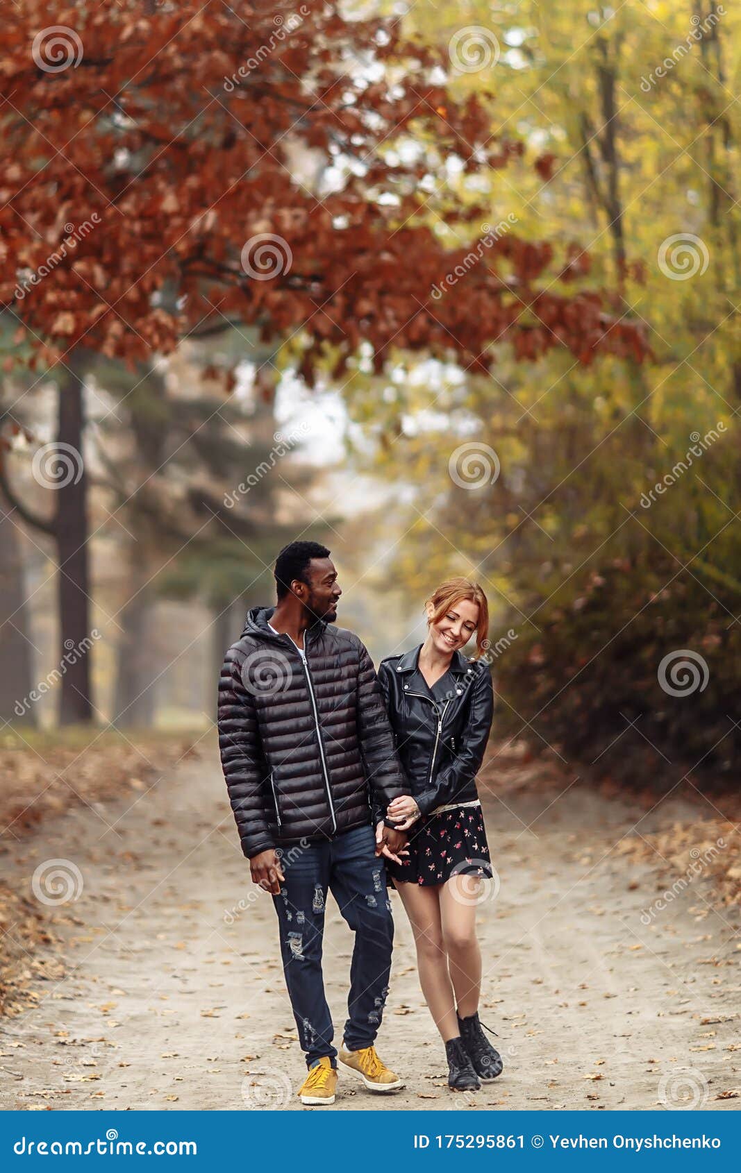 Happy Interracial Couple Walking In Autumn Park Stock