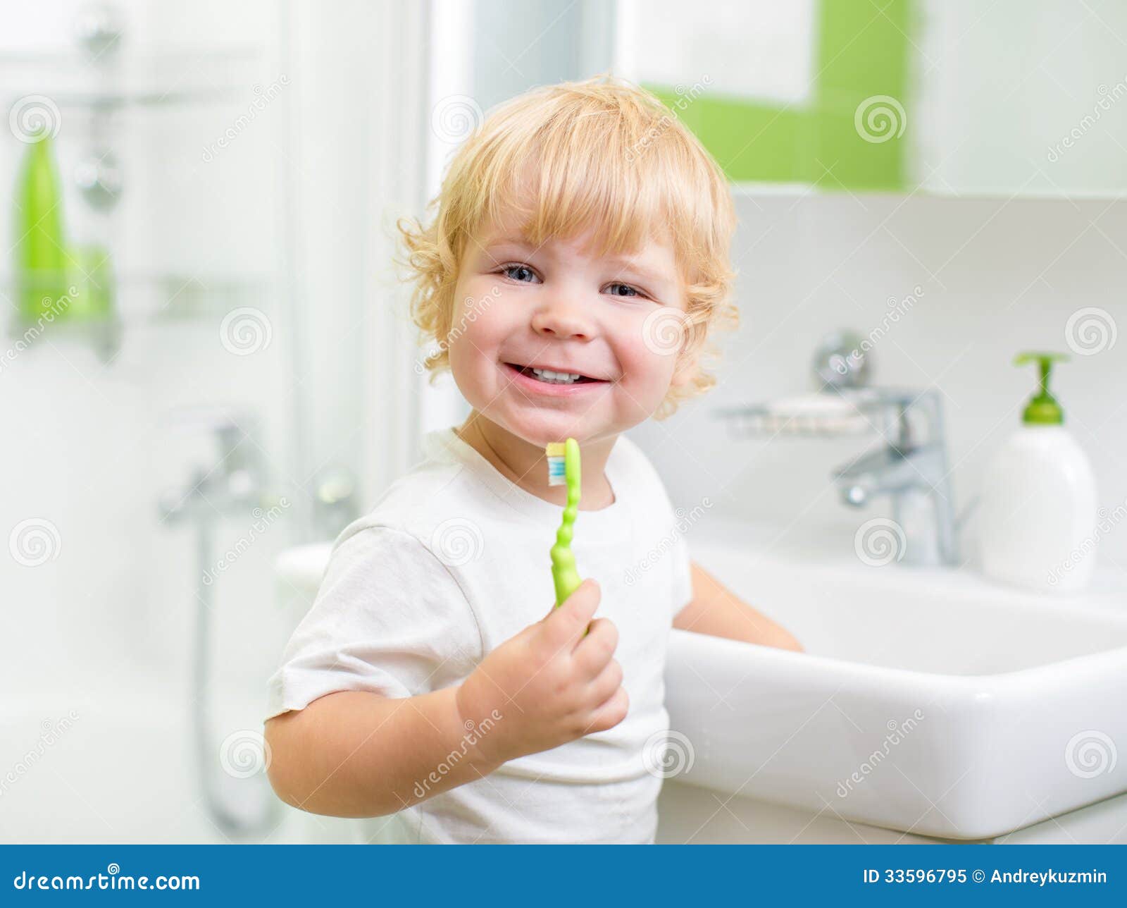 happy kid or child brushing teeth in bathroom