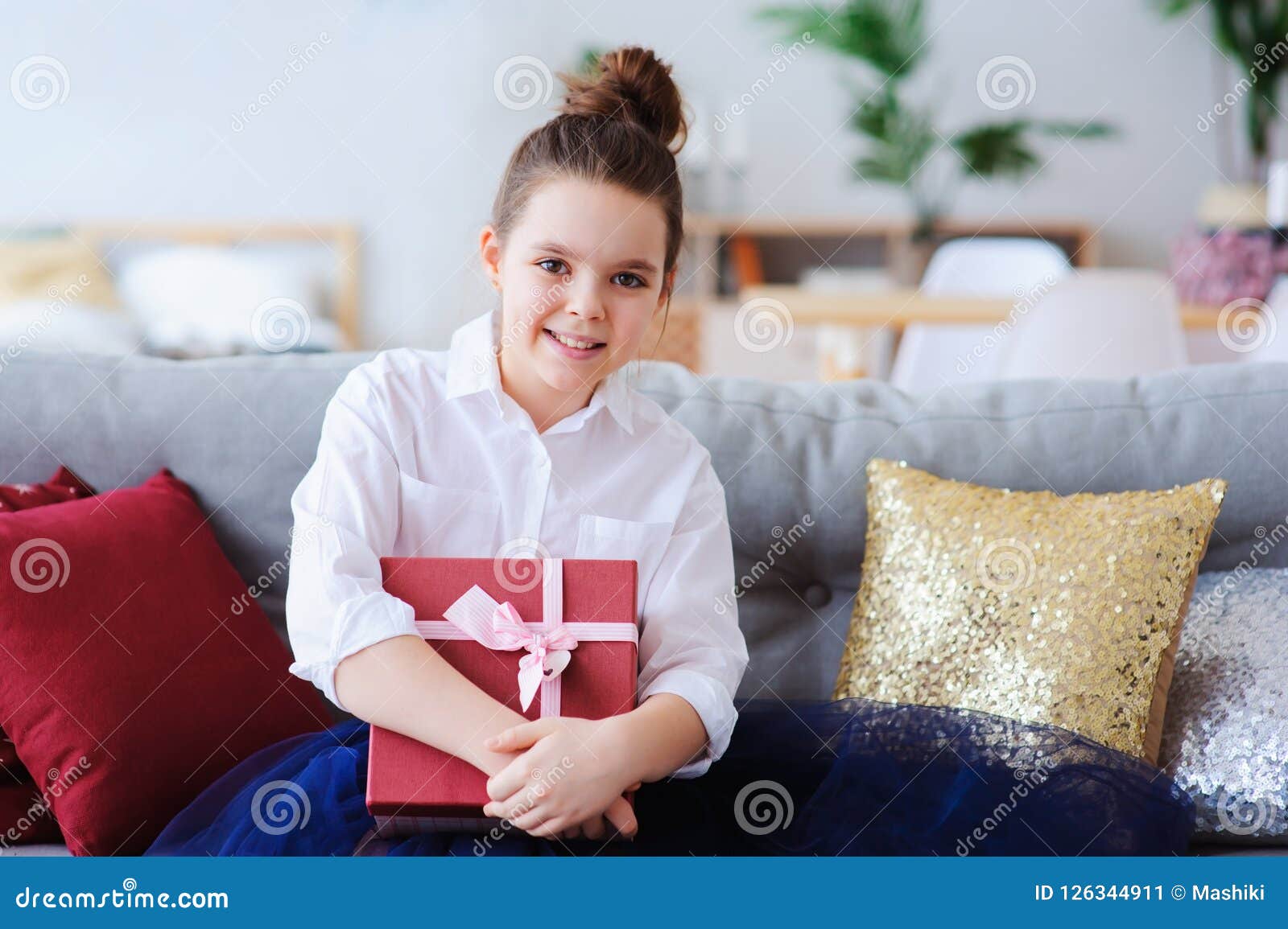 Happy Kid Girl with Gift for Birthday or Christmas Posing at Home in ...