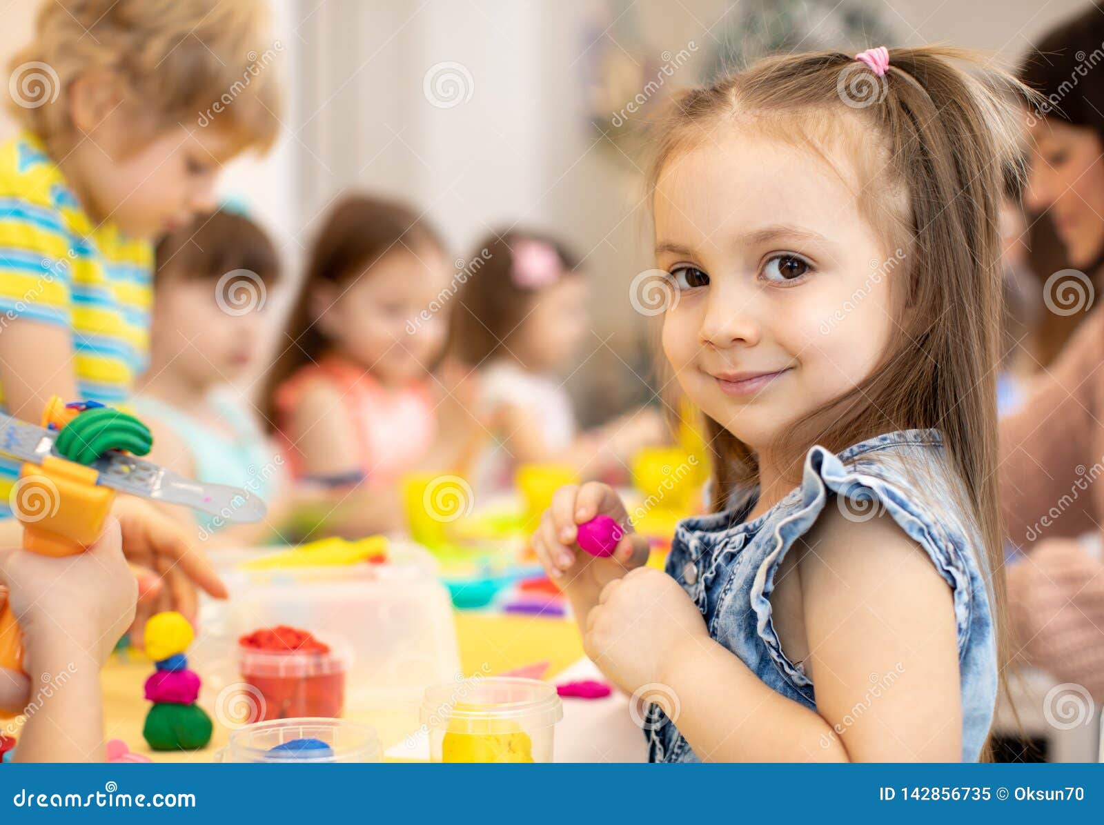 happy kids doing arts and crafts in day care centre