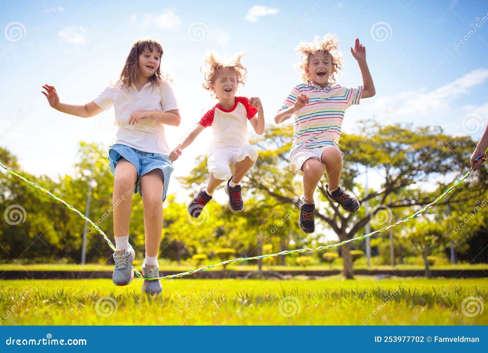 Happy Kids Play Outdoor. Children Skipping Rope Stock Photo - Image of