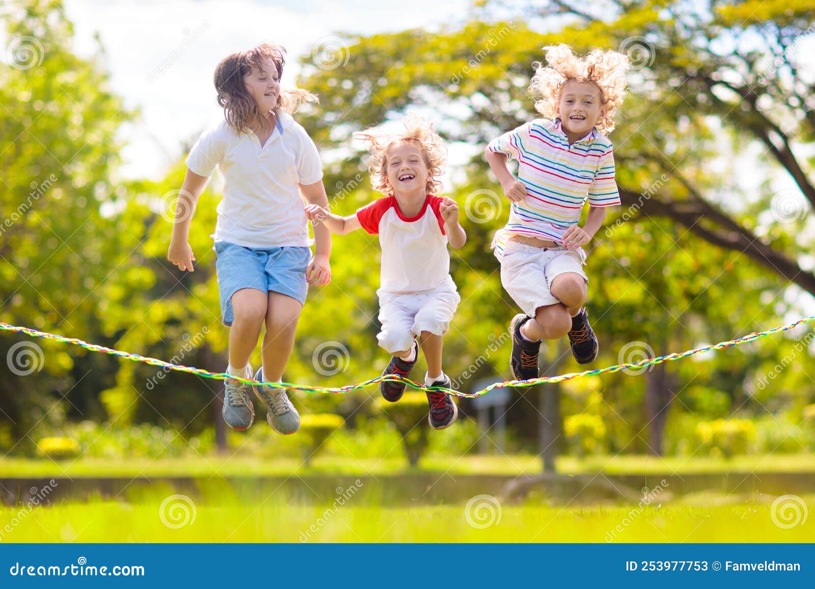 Happy Kids Play Outdoor. Children Skipping Rope Stock Image - Image of