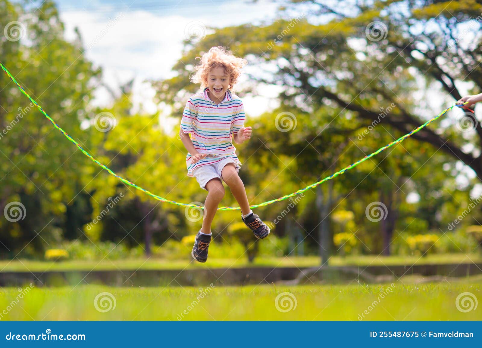 Happy Kids Play Outdoor. Children Skipping Rope Stock Image - Image of