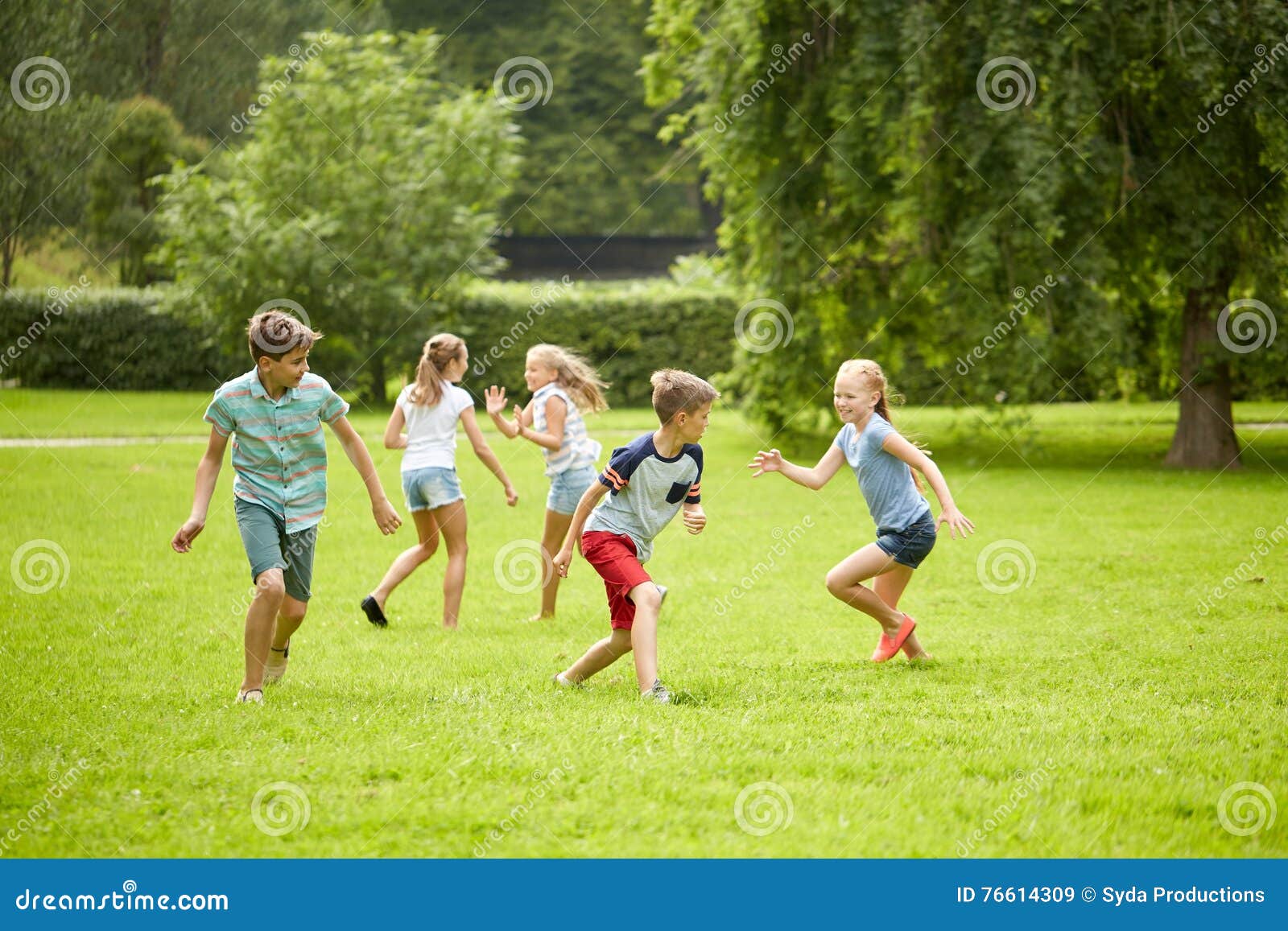 happy kids running and playing game outdoors