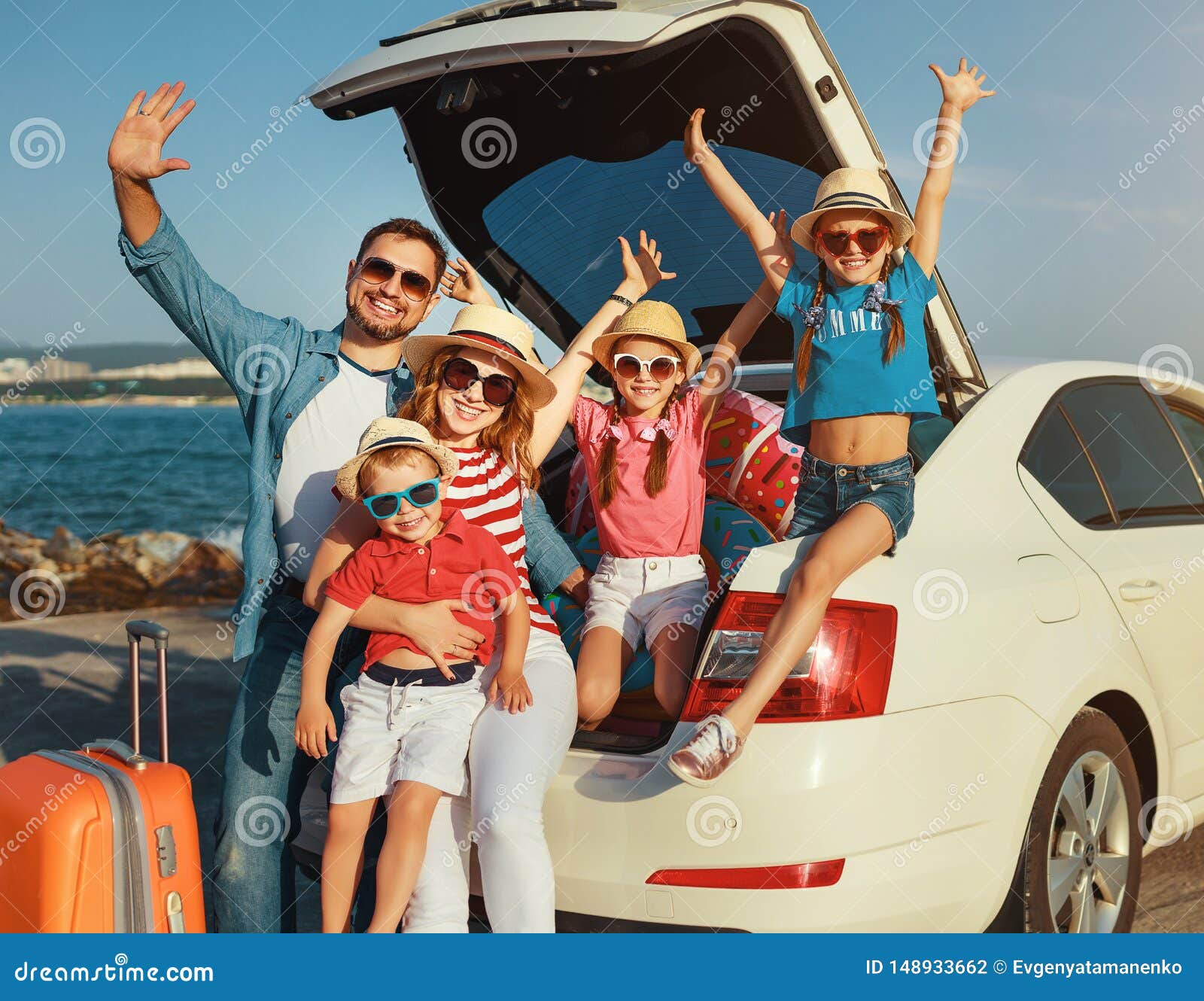 happy large family  in summer auto journey travel by car on beach