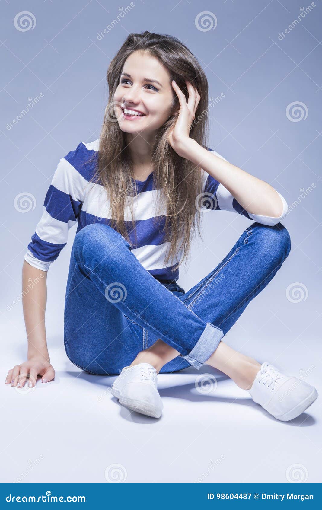 Happy Laughing Caucasian Brunette Girl on Floor with Crossed Legs and ...