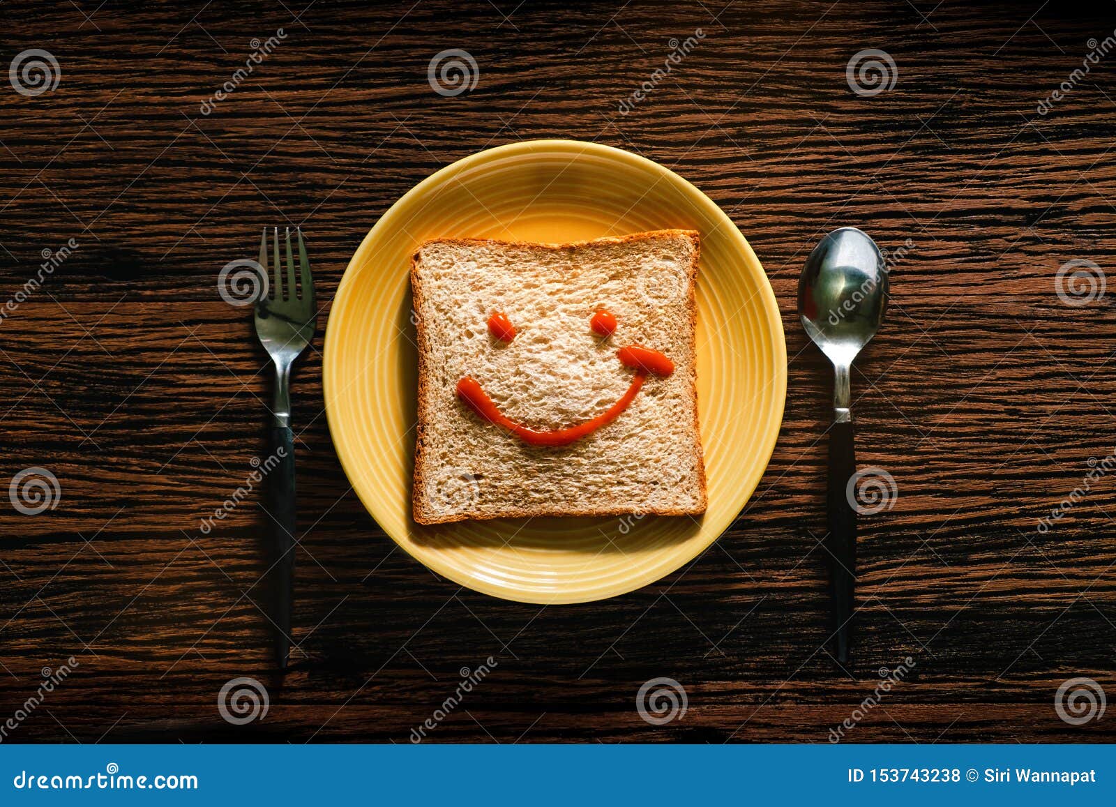 Happy Life Concept. Bread on Plate with Spoon and Fork for Breakfast