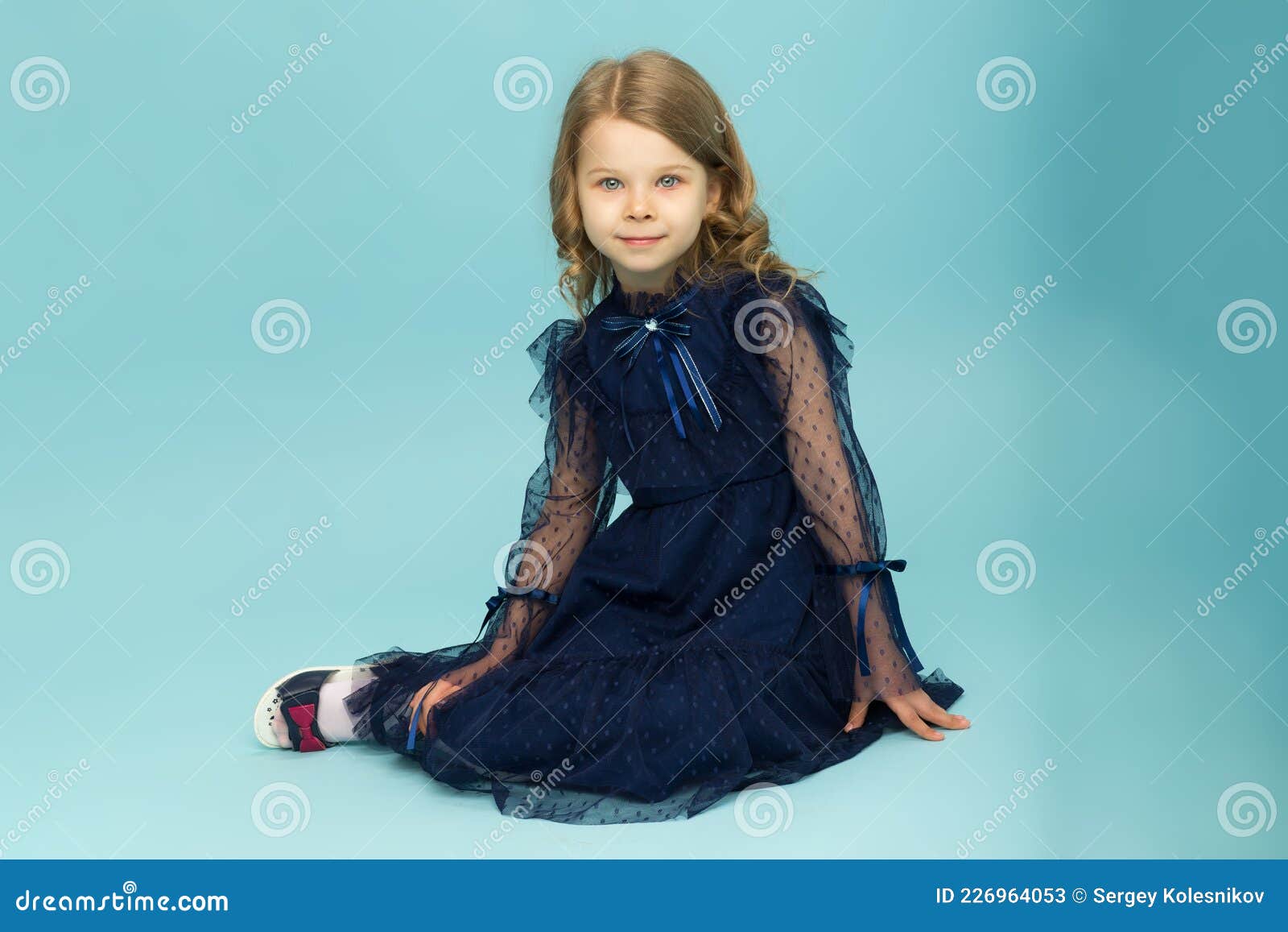 Happy Little Girl in Blue Dress Sitting on Floor Stock Image - Image of ...