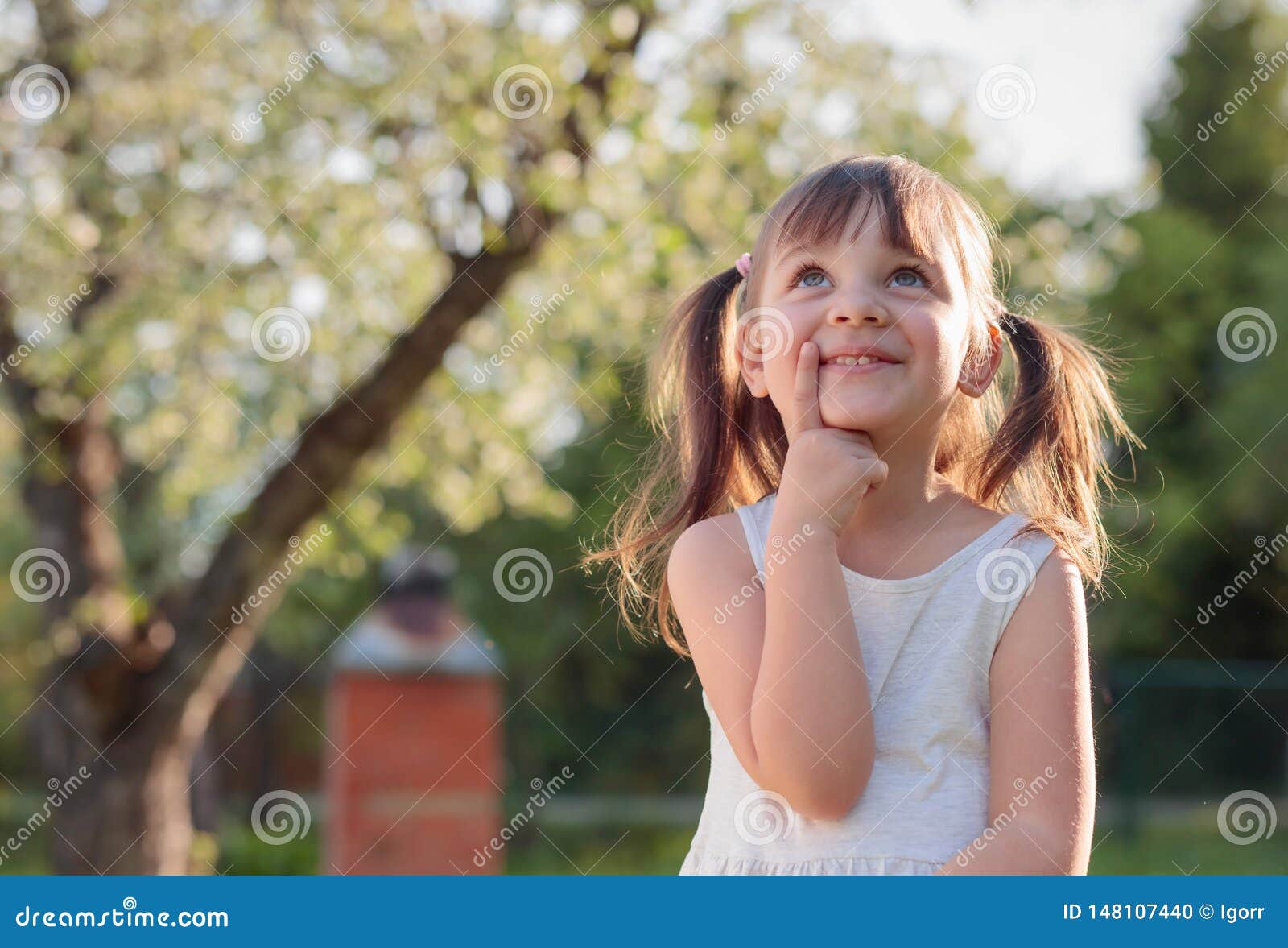 Happy Little Girl Dreaming in the Garden Stock Photo - Image of child ...