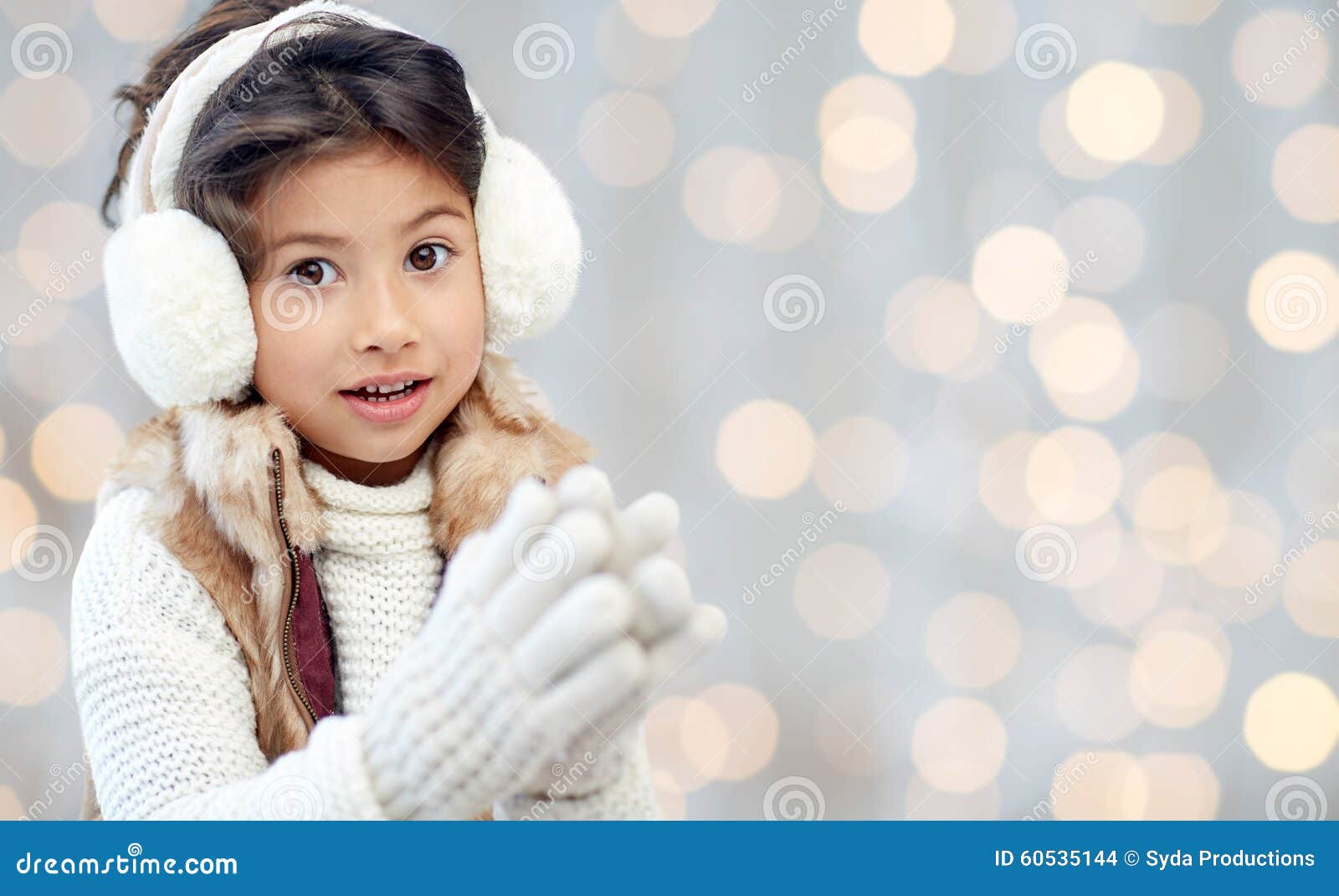 Happy Little Girl in Earmuffs Over Holidays Lights Stock Photo - Image ...