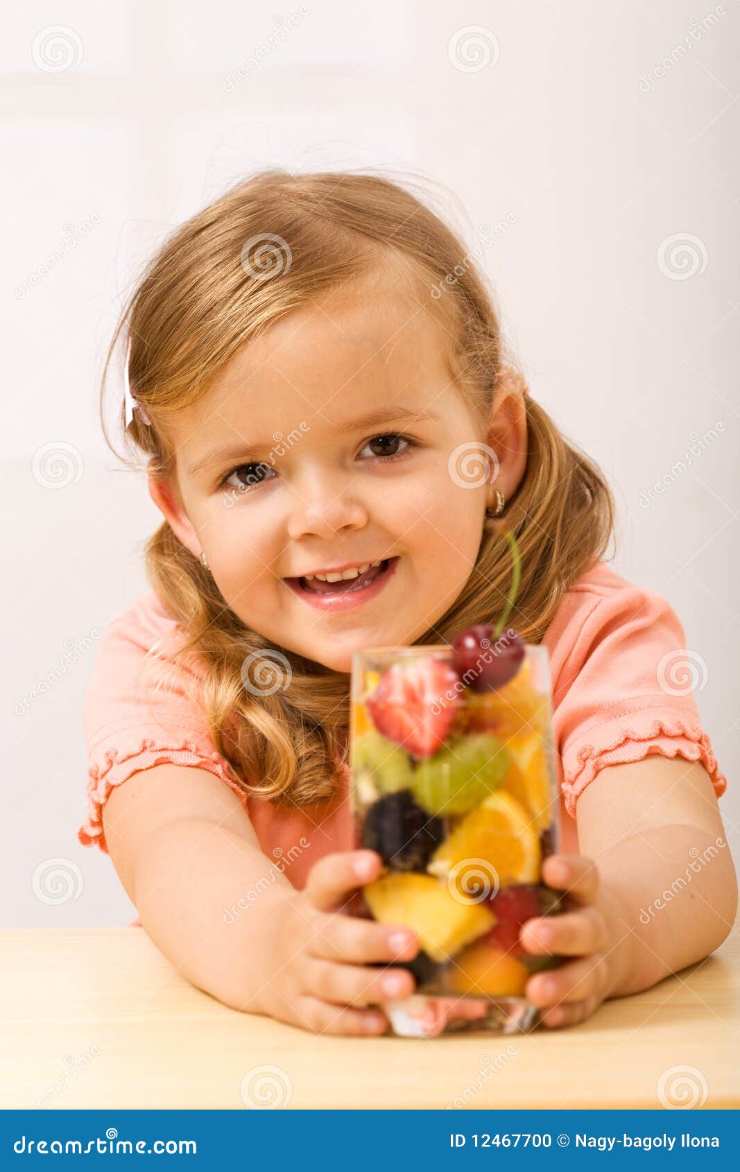 happy little girl with fruity refreshment