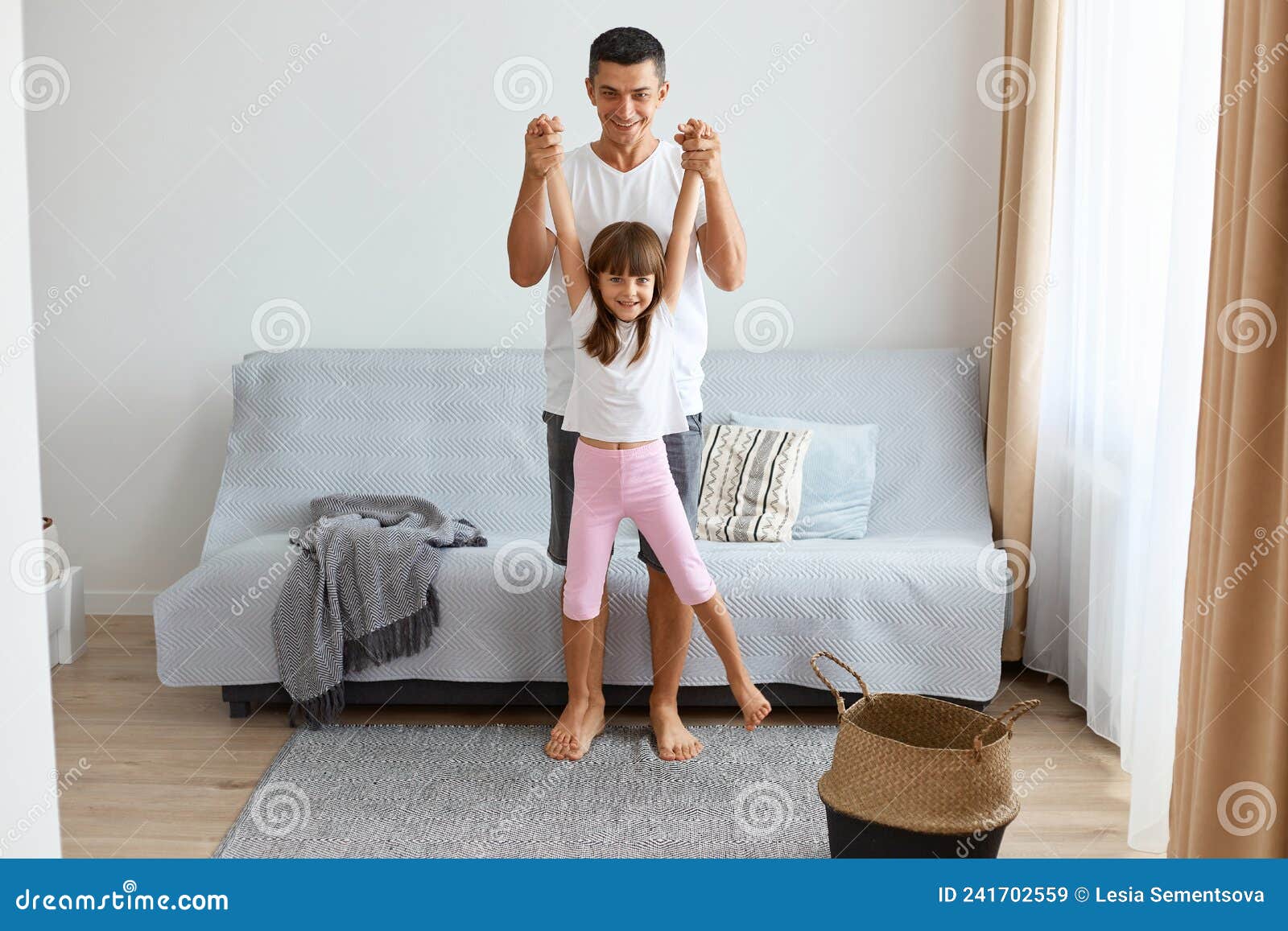 Happy Little Girl Playing with Her Father Together in the Living Room ...