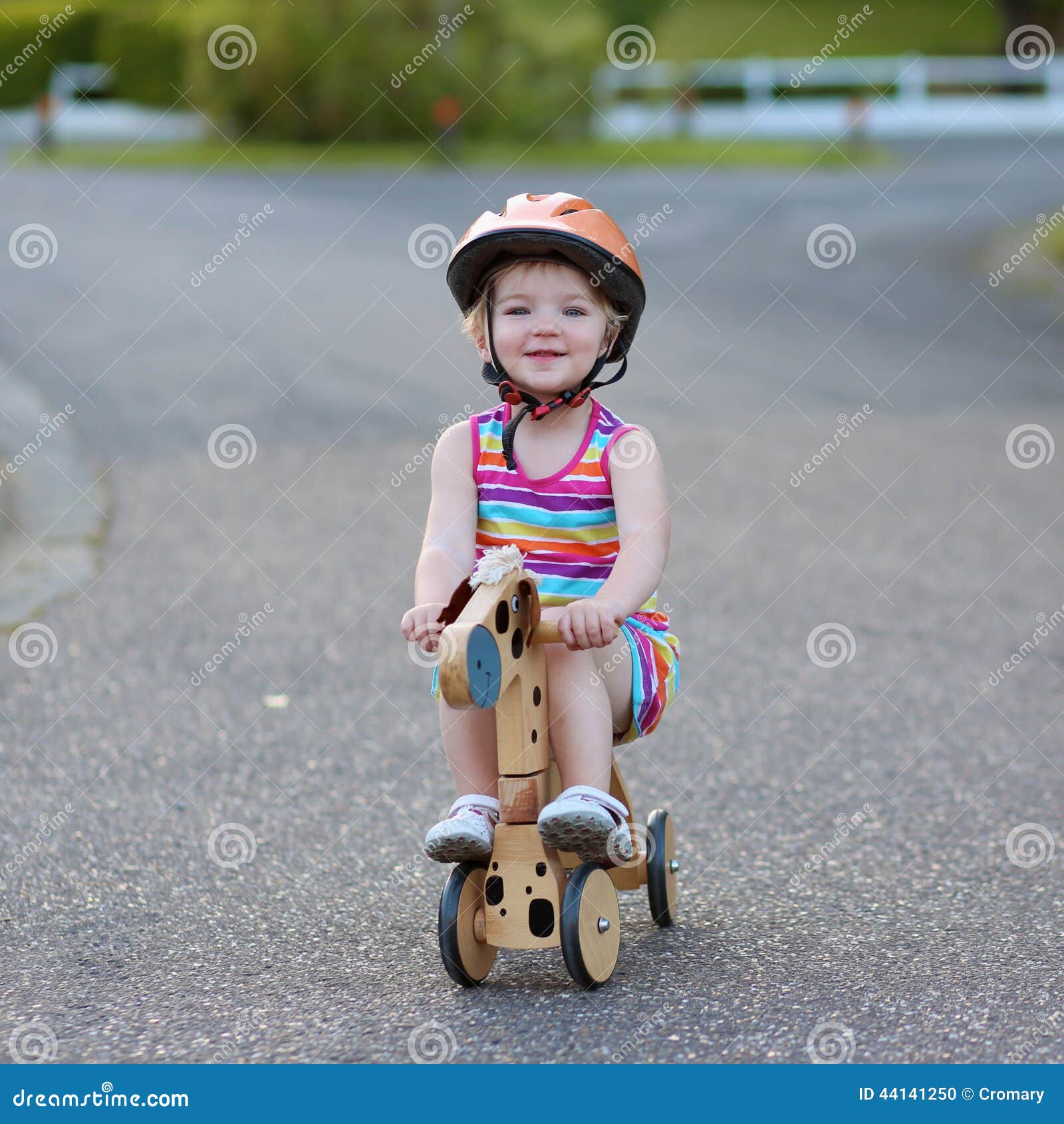 girl riding tricycle