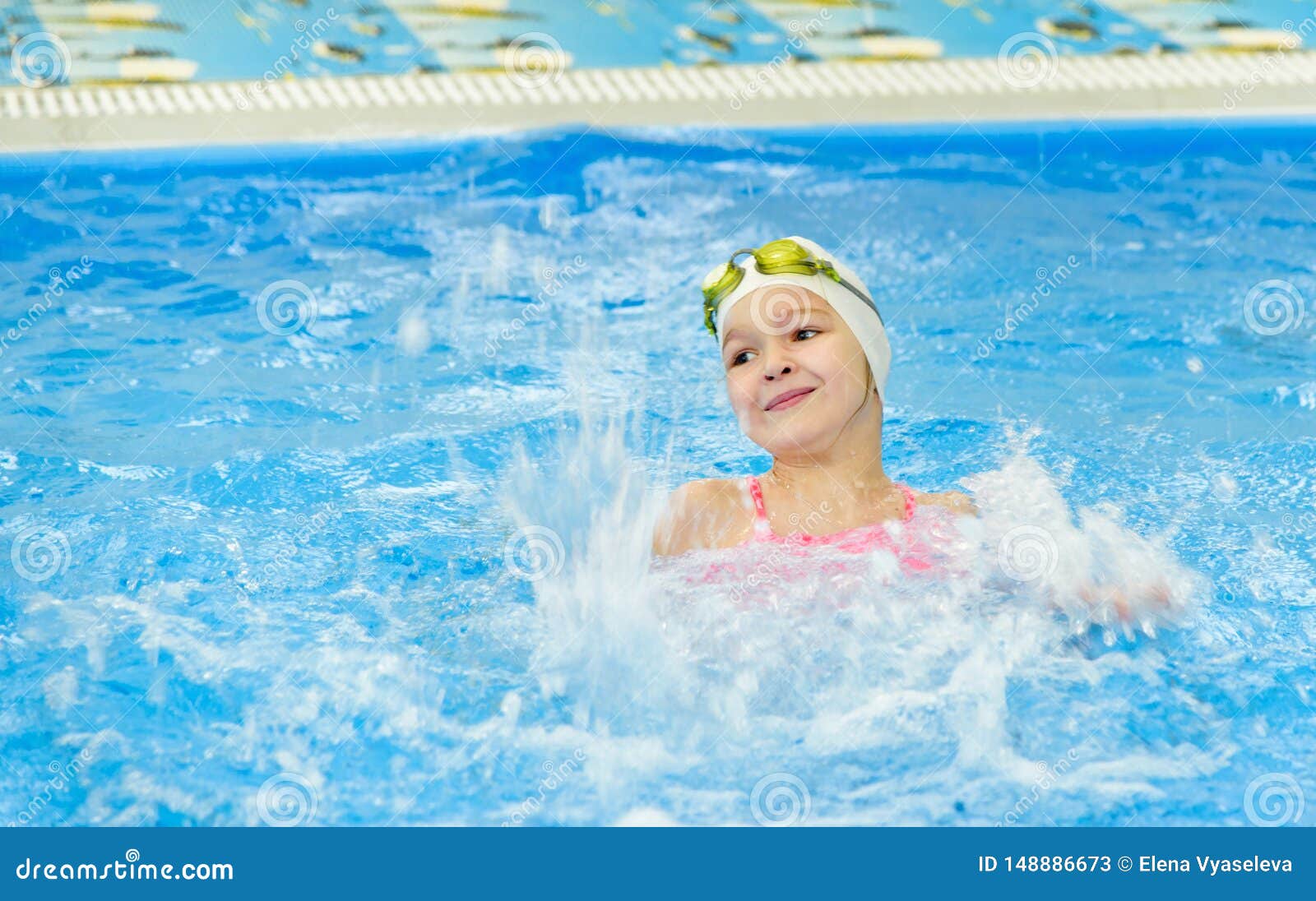 Happy Little Girl Swimming In The Pool. Caucasian Child Is
