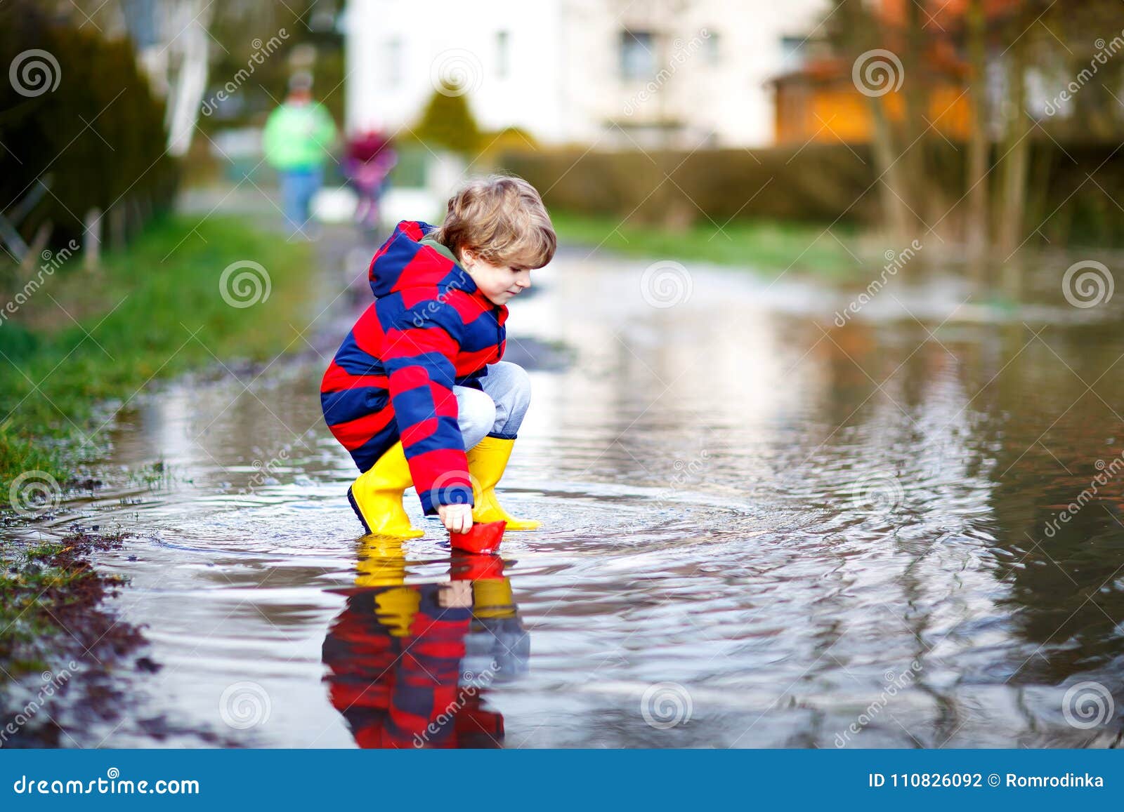 Happy Little Kid Boy in Yellow Rain Boots Playing with Paper Ship Boat ...