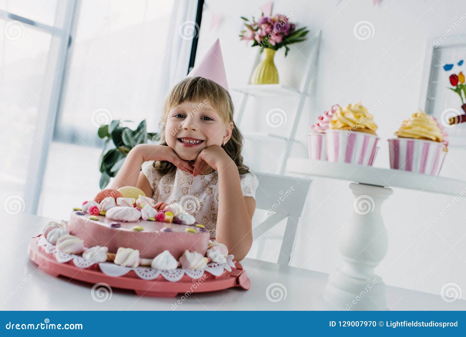 Happy Little Kid in Cone Sitting at Table with Birthday Cake Stock ...