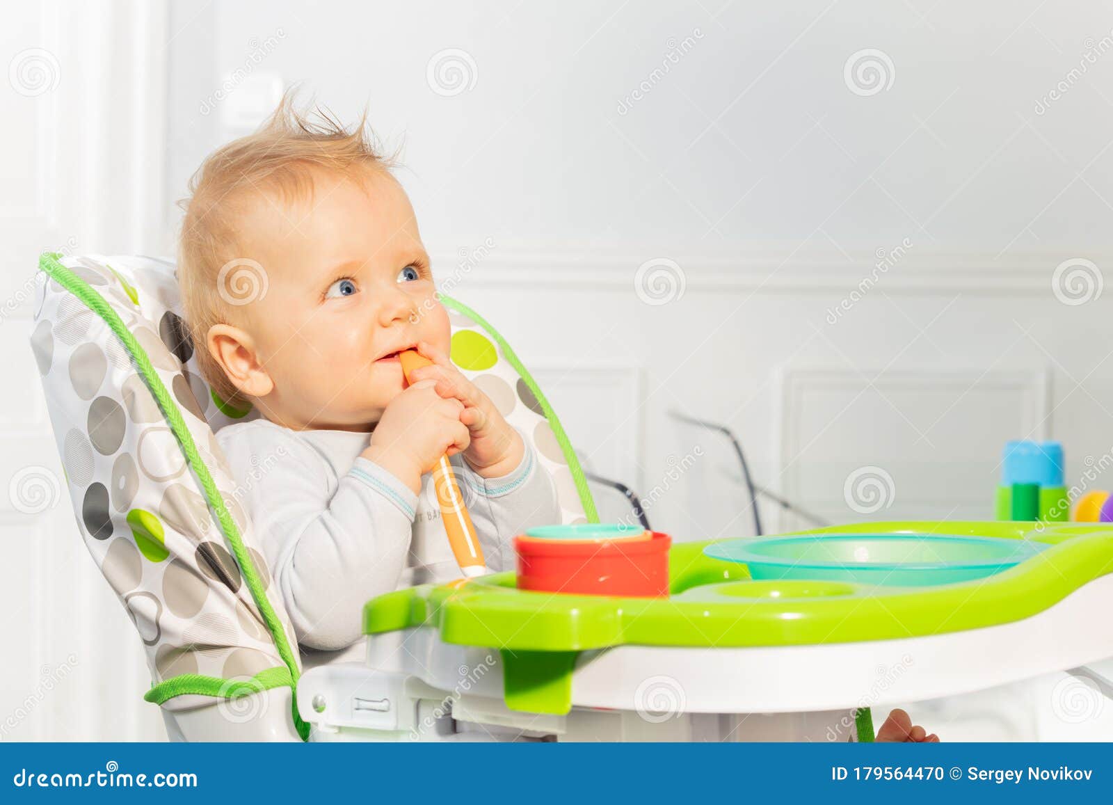 A Little Boy Is Sitting On A Chair. Stock Image - Image of 