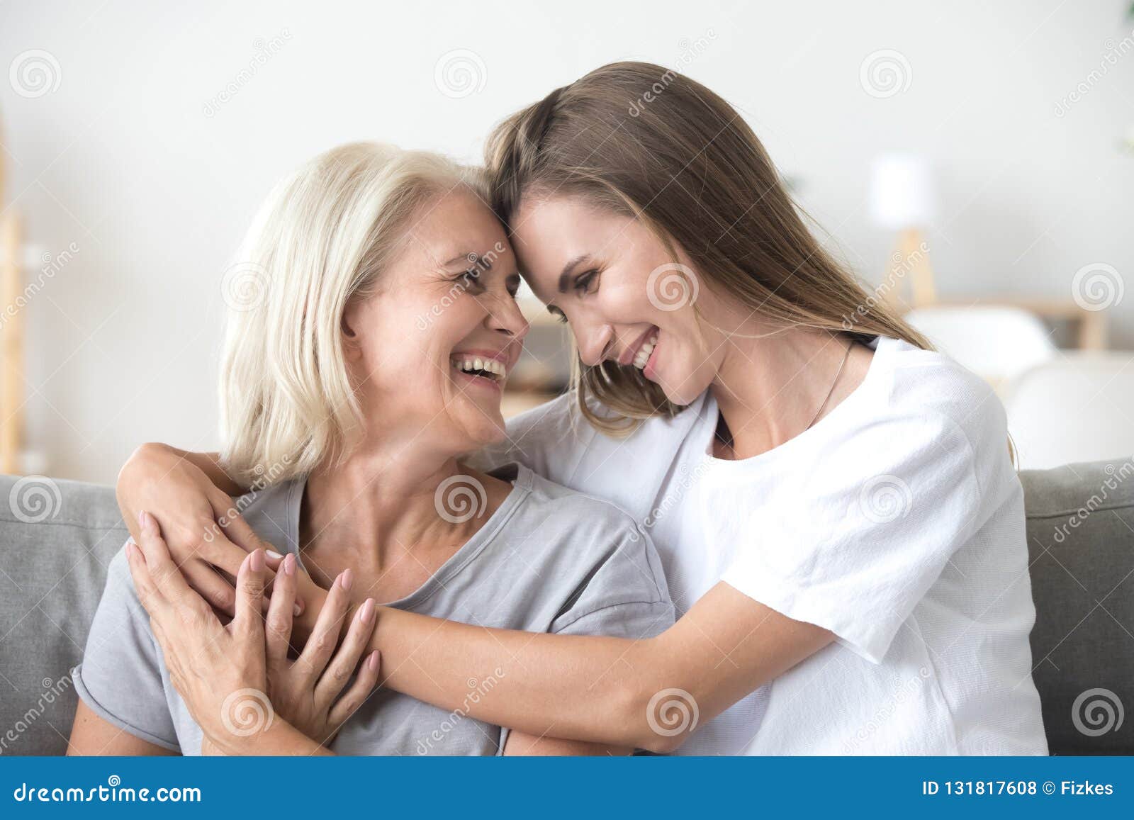 happy loving older mother and grown millennial daughter laughing