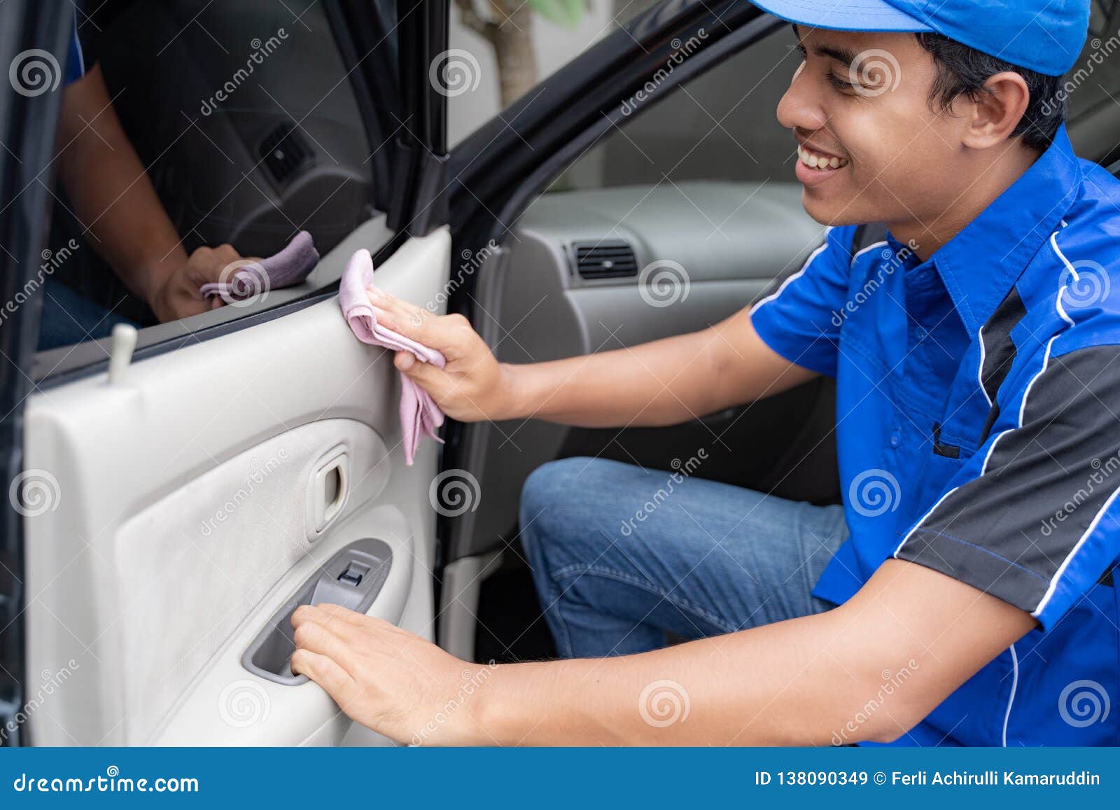 Male Car Cleaning Service Worker Washing Black Car Stock