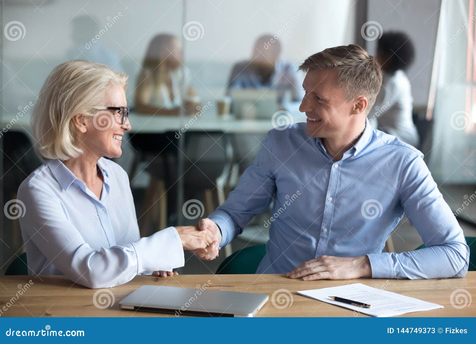 happy male client employee handshake broker hr manager at meeting