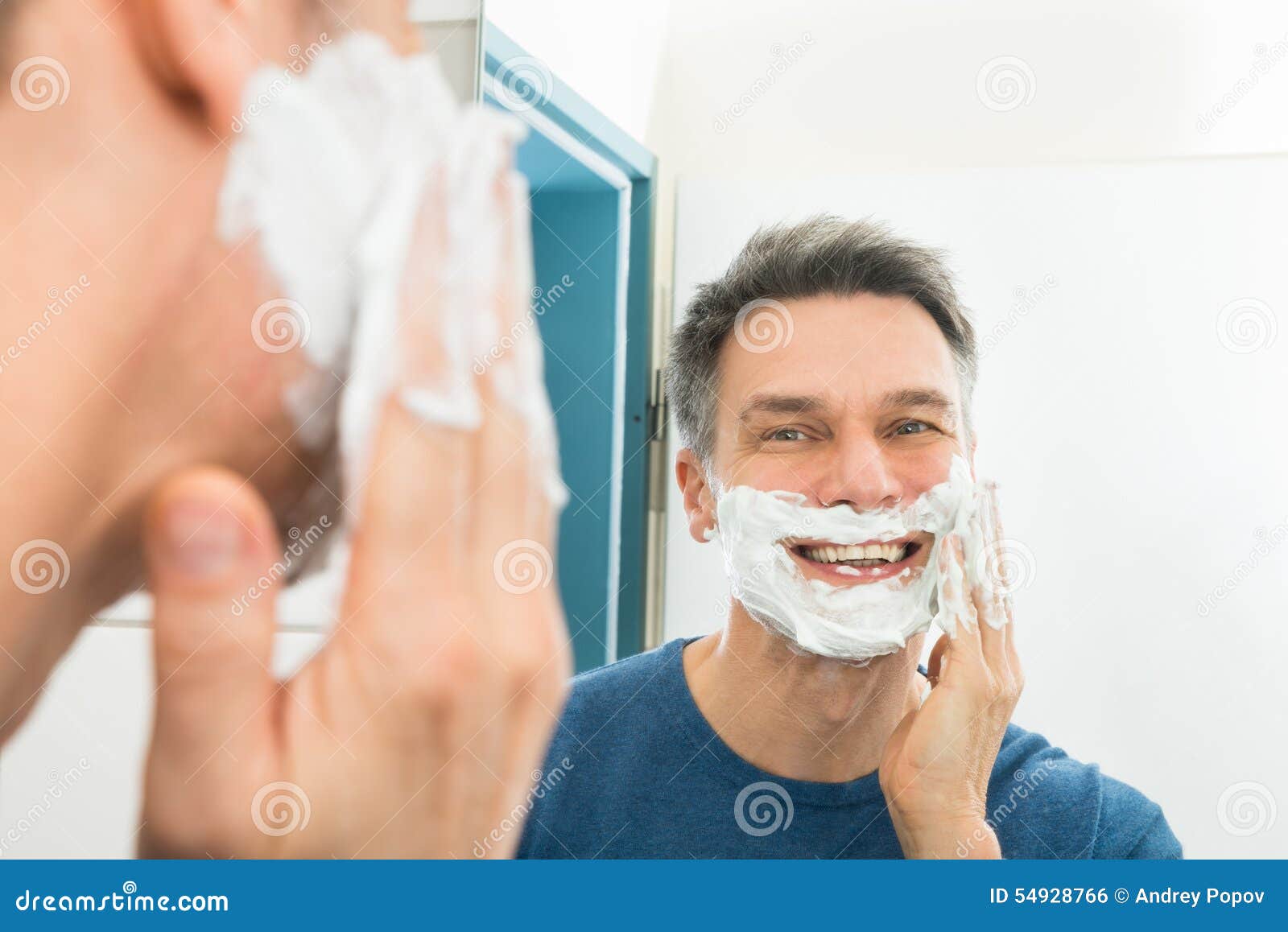 Happy Man Shaving Using Razor With Cream Foam. Stock Photo