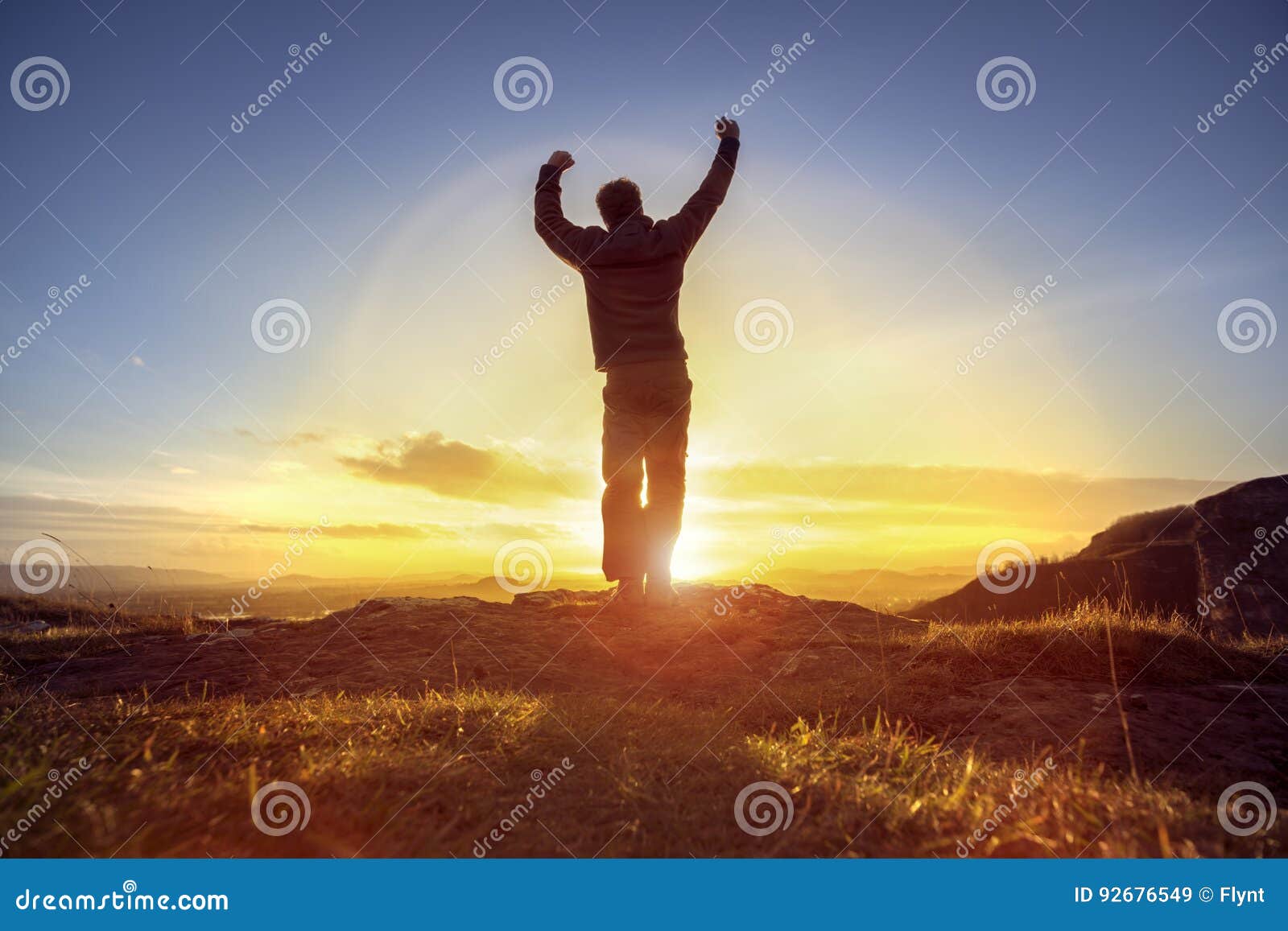 happy man celebrating winning success against sunset