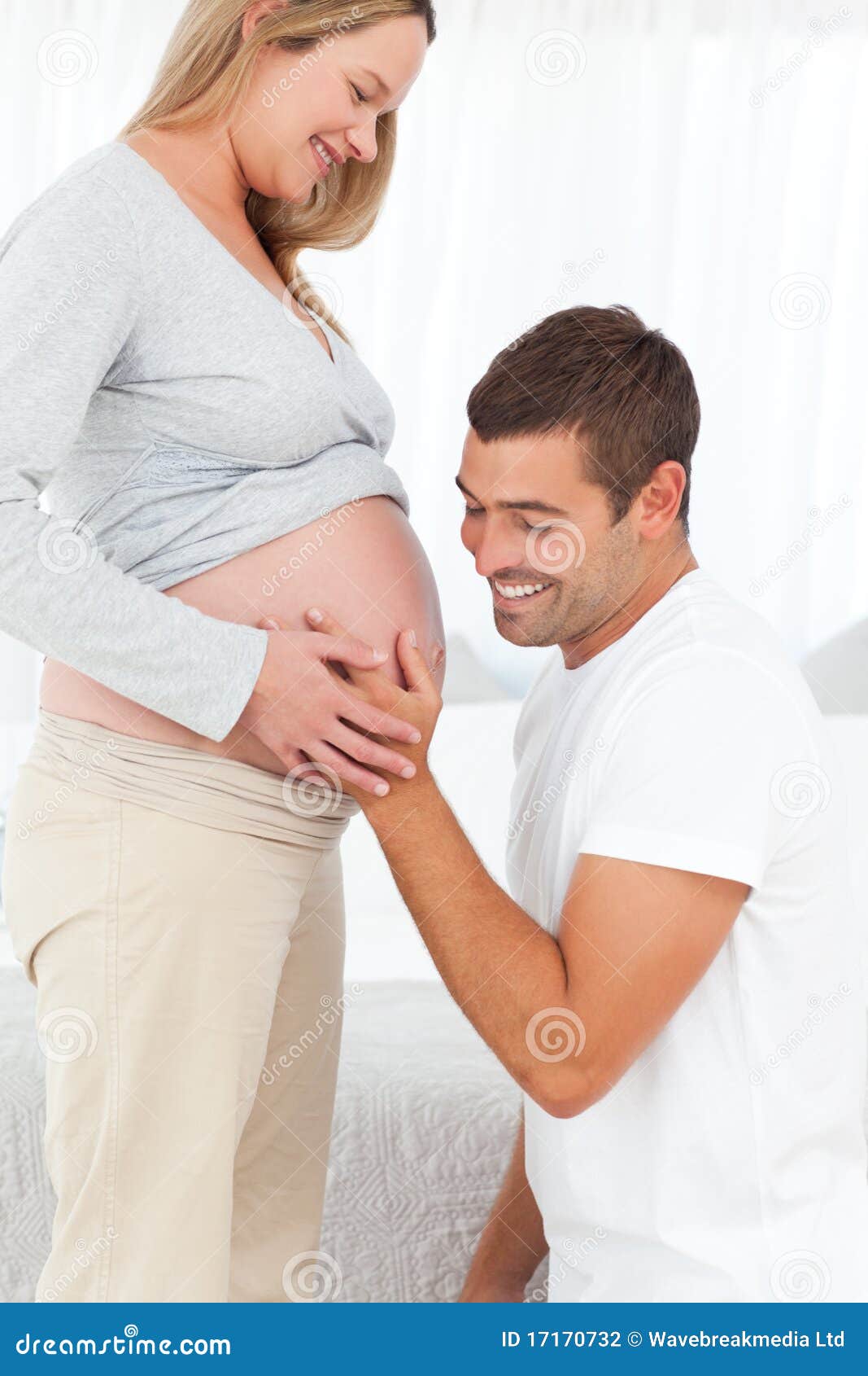 Happy Man Feeling The Belly Of His Pregnant Wife Stock