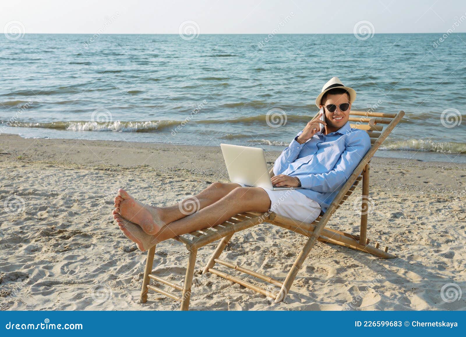 Happy Man with Laptop Talking by Mobile Phone on Beach. Business Trip ...