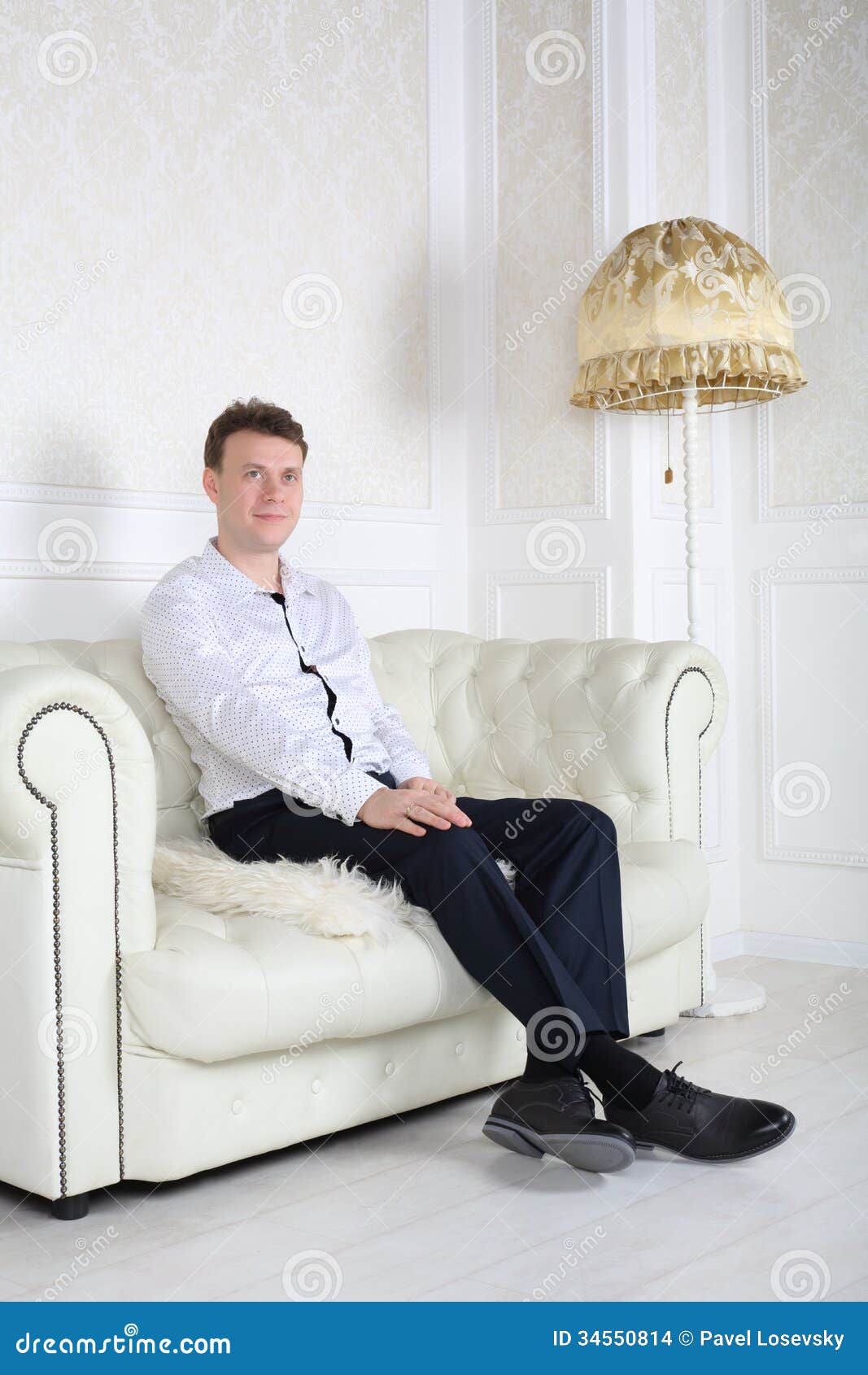 Happy Man  In Shirt Sits On Sofa And Dreams Stock Photo 