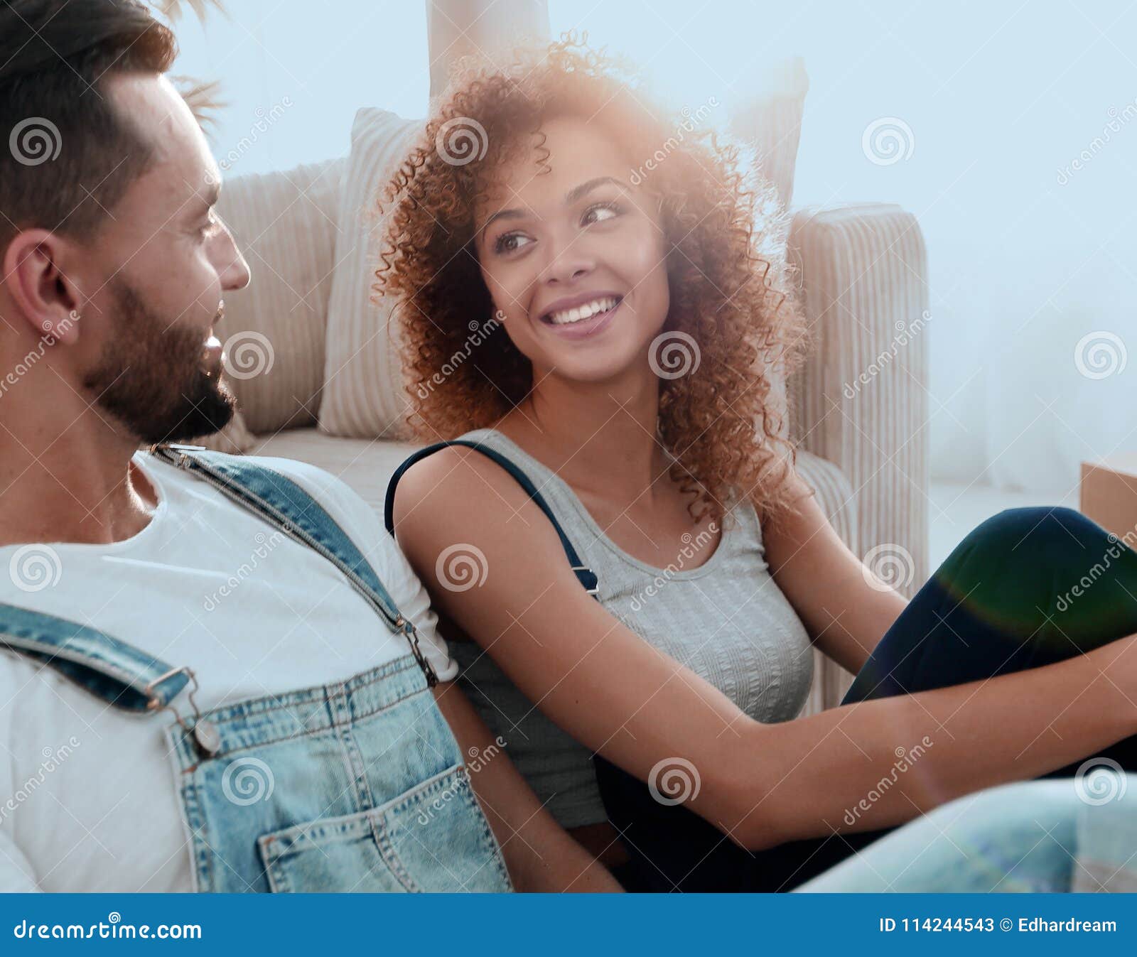 Closeup Of A Happy Married Couple Sitting In A New Apart