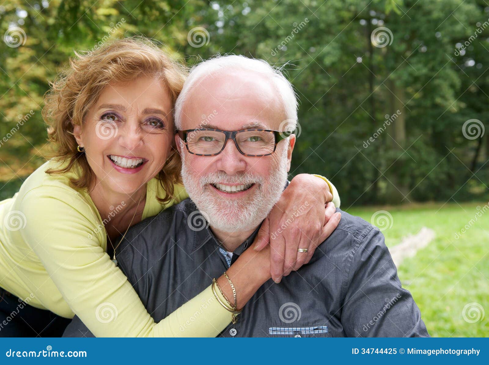 happy married couple smiling together outdoors