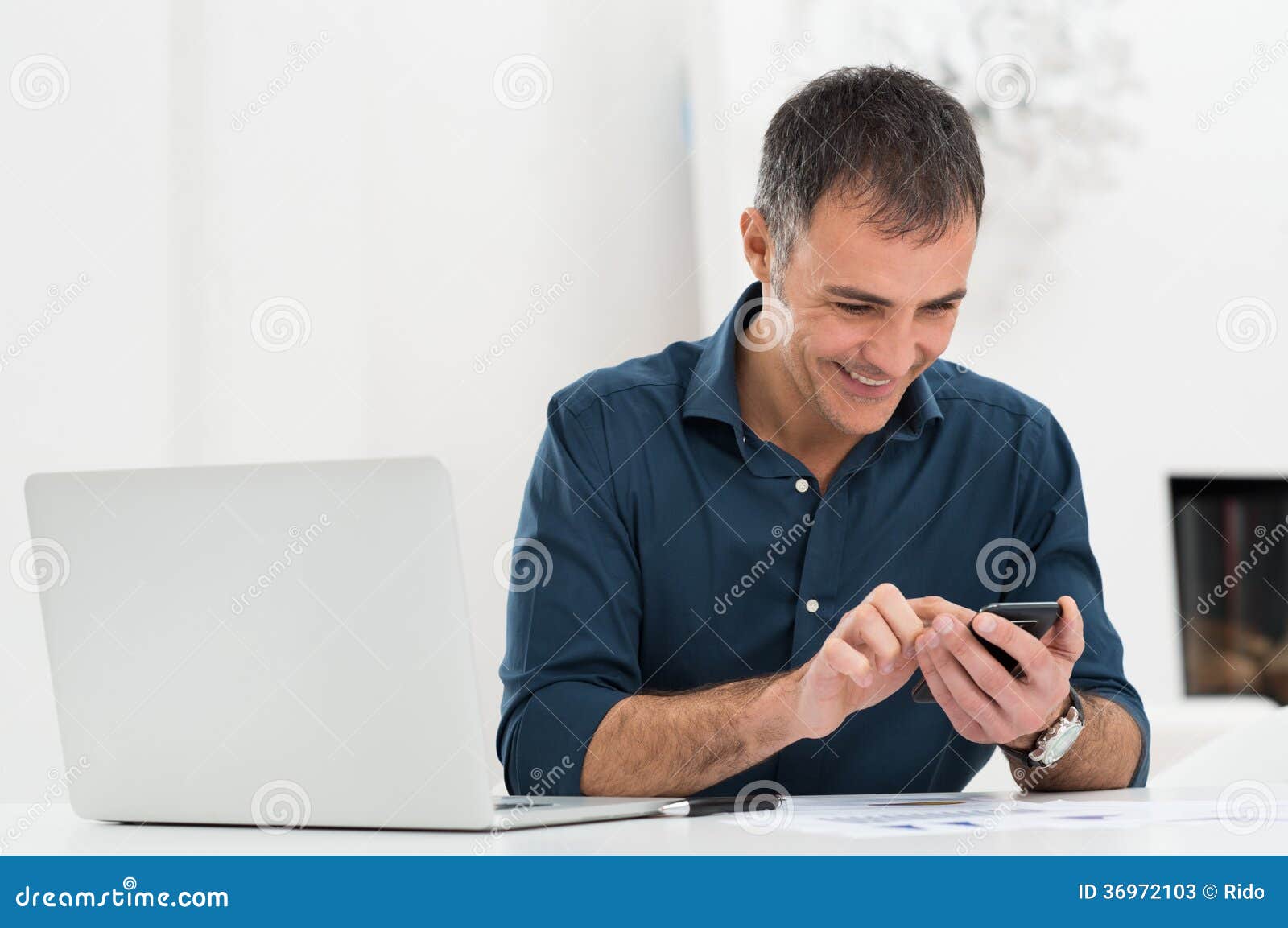 happy mature man using cellphone