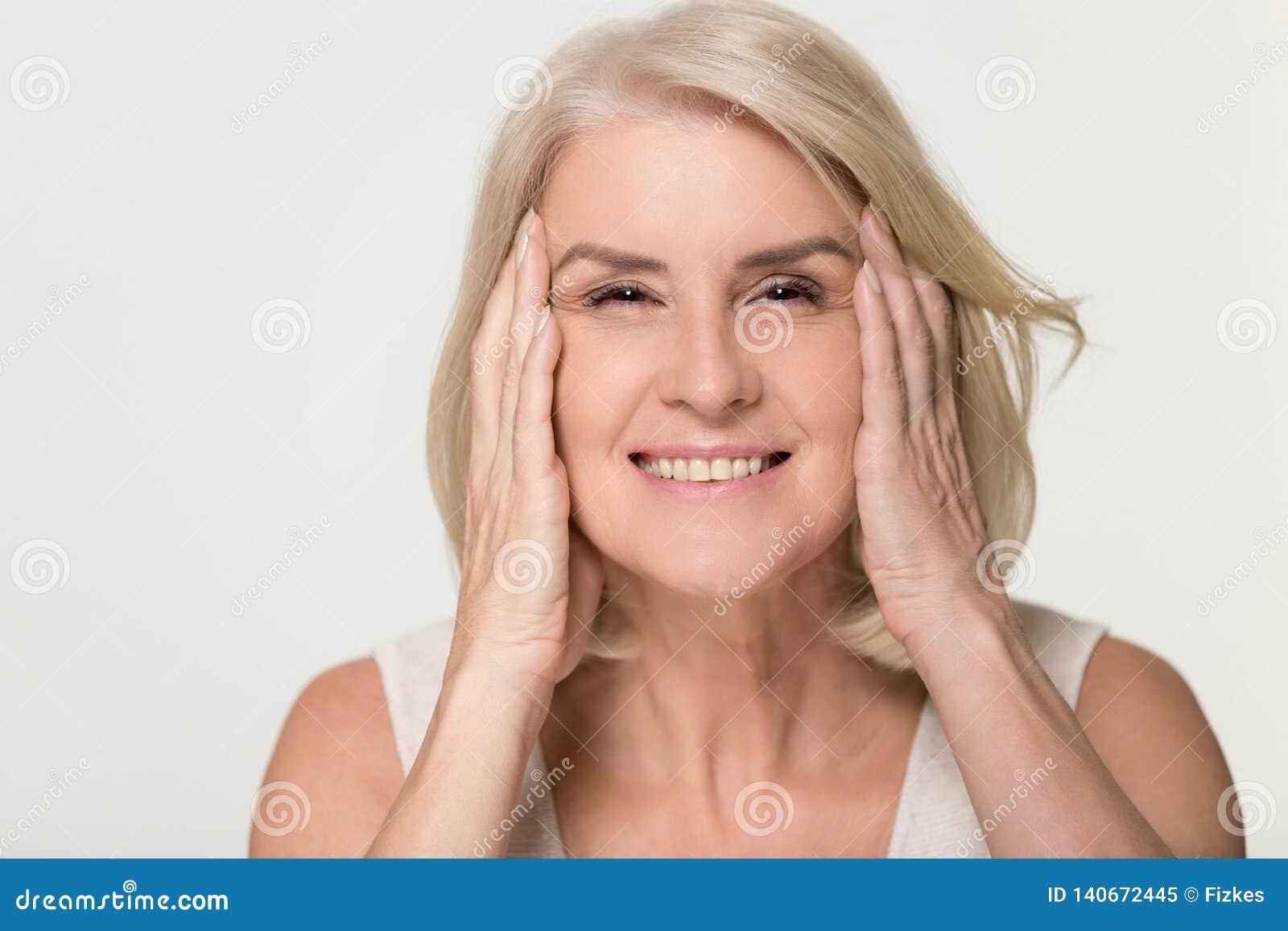 happy mature woman touching face , anti aging beauty concept