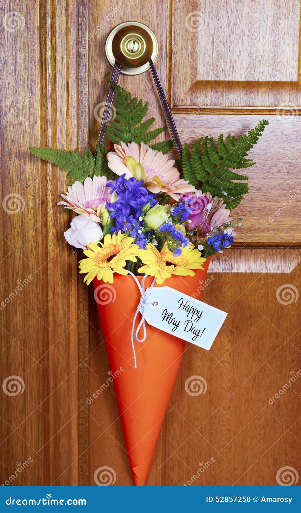 happy may day gift of flowers on door.