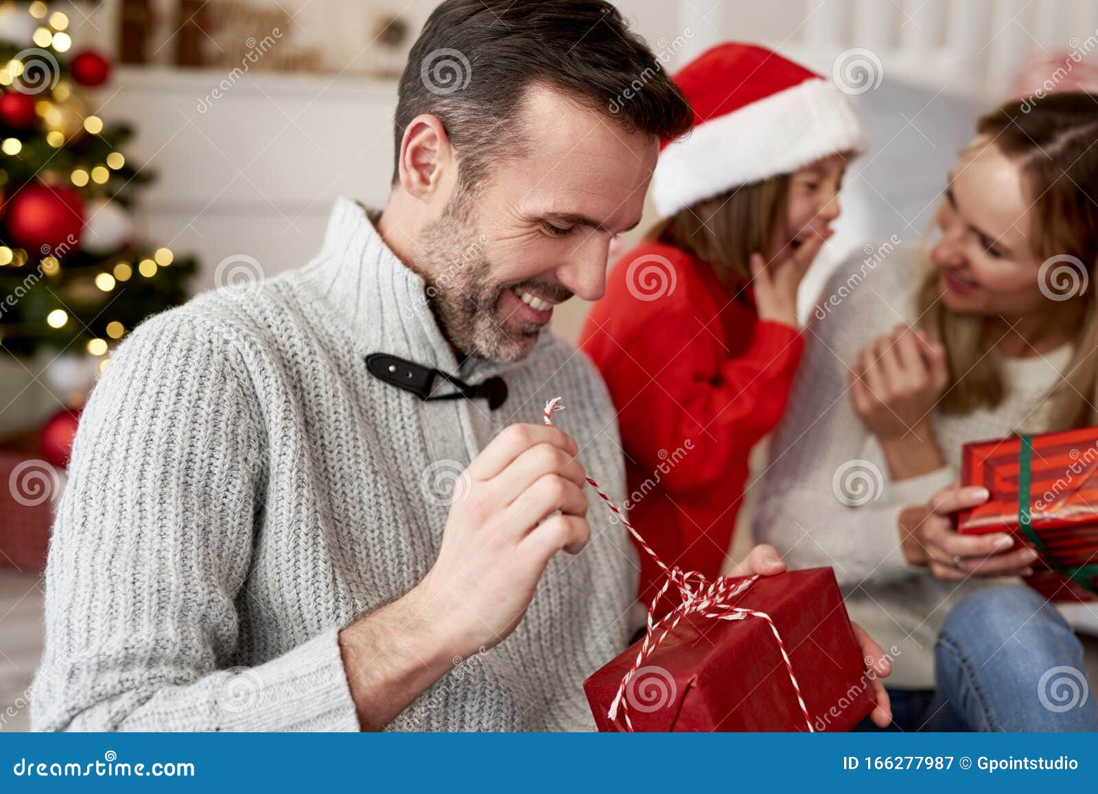 Happy Man Opening Christmas Present Stock Image Image Of Christmas Indoors