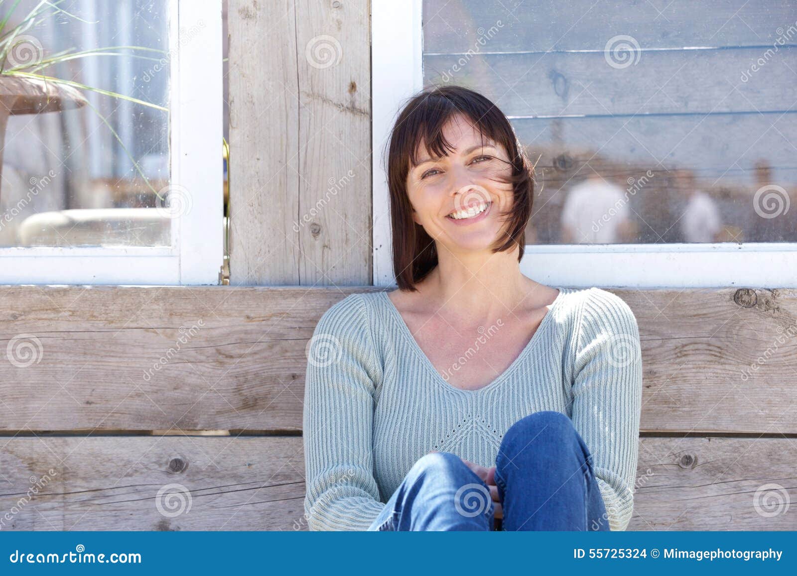 happy middle aged woman smiling outdoors