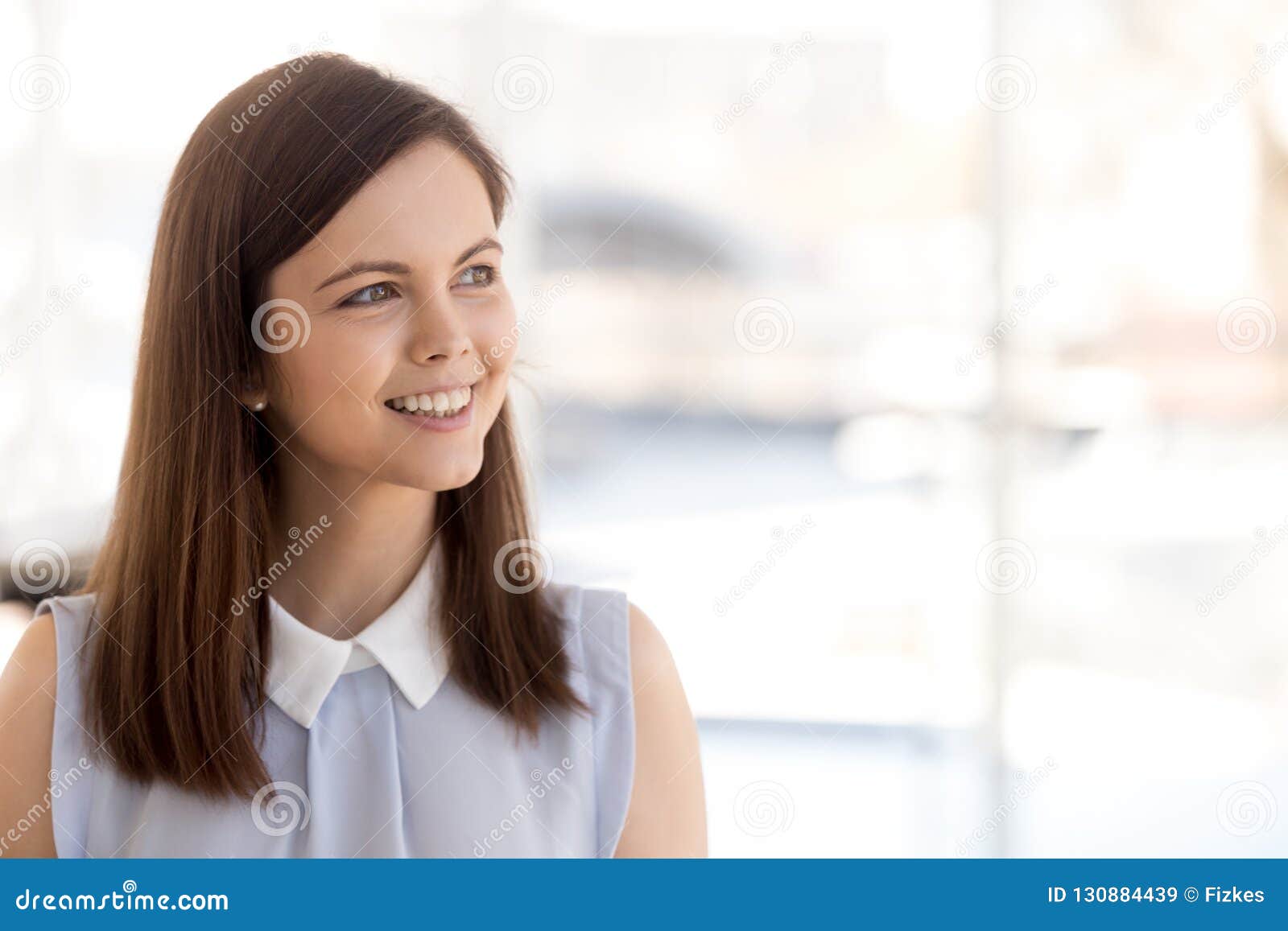 happy millennial female employee look in distance dreaming