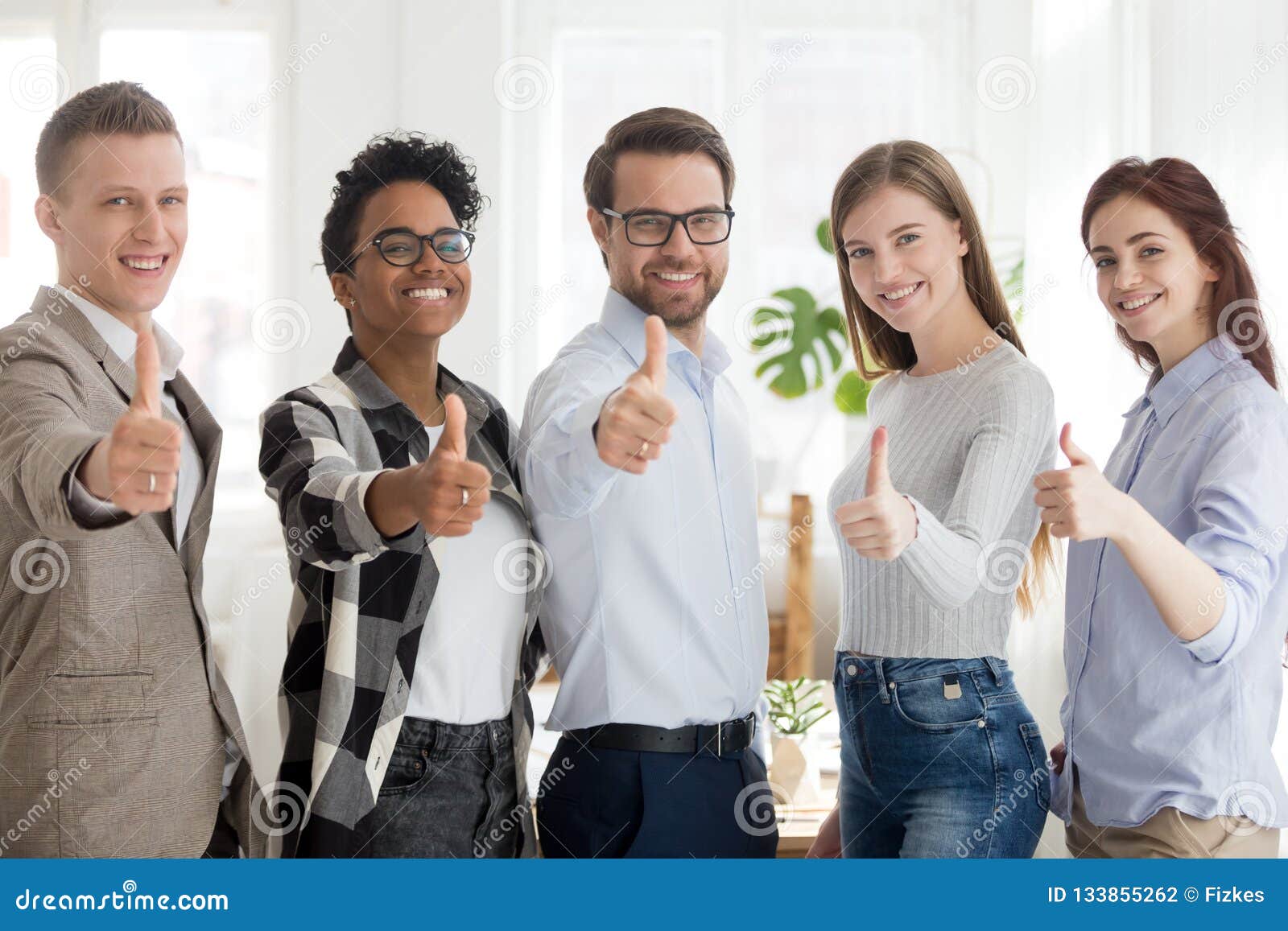 happy millennial people standing showing thumbs up