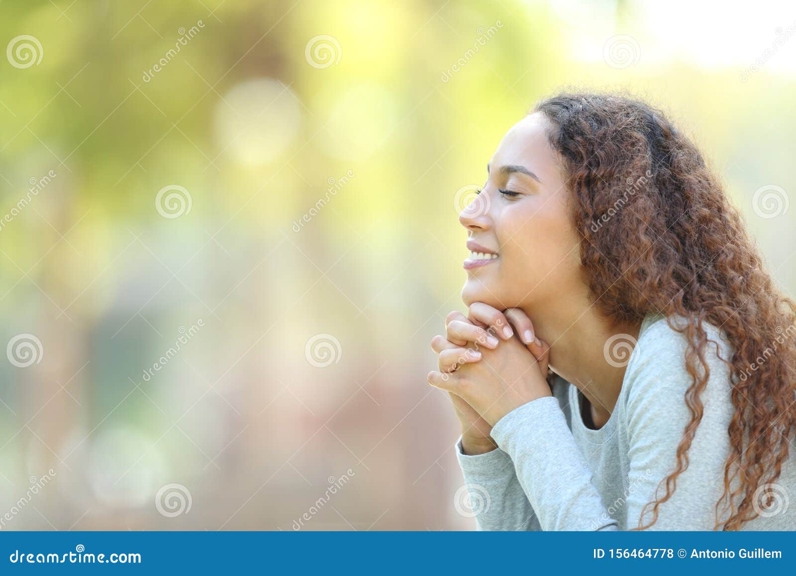 happy mixed race woman meditating outdoors